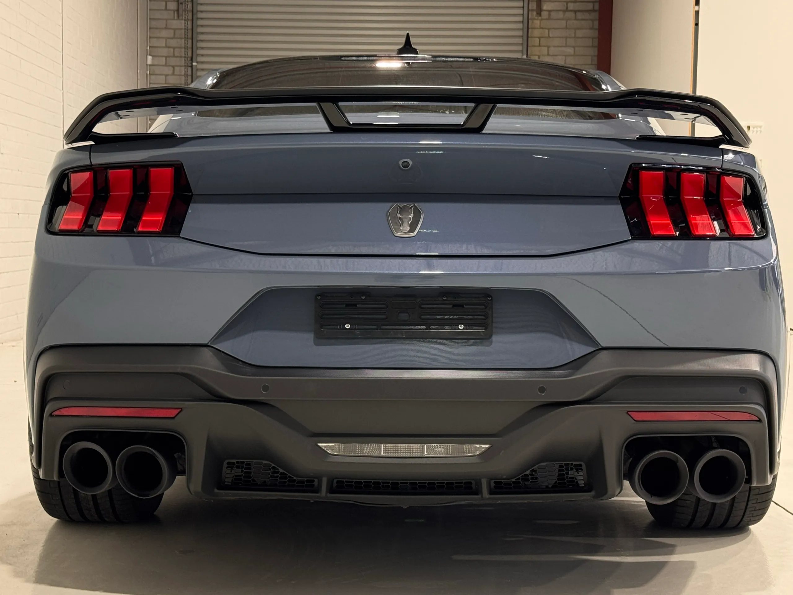 Rear view of the Ford Mustang Dark Horse showing its spoiler, rear lights and four exhaust outlets