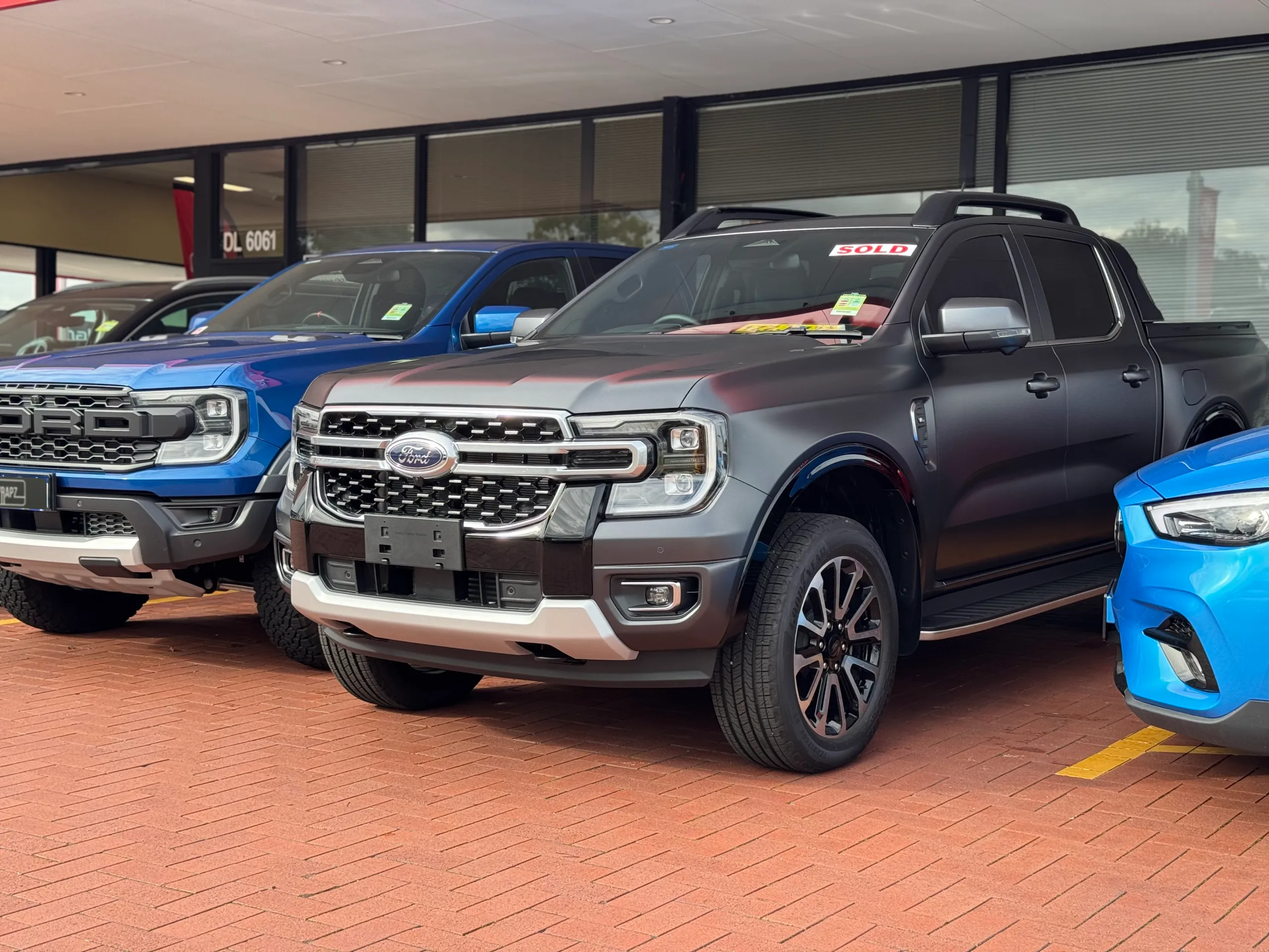 Satin grey Ford Ranger Platinum parked among other vehicles at a dealership
