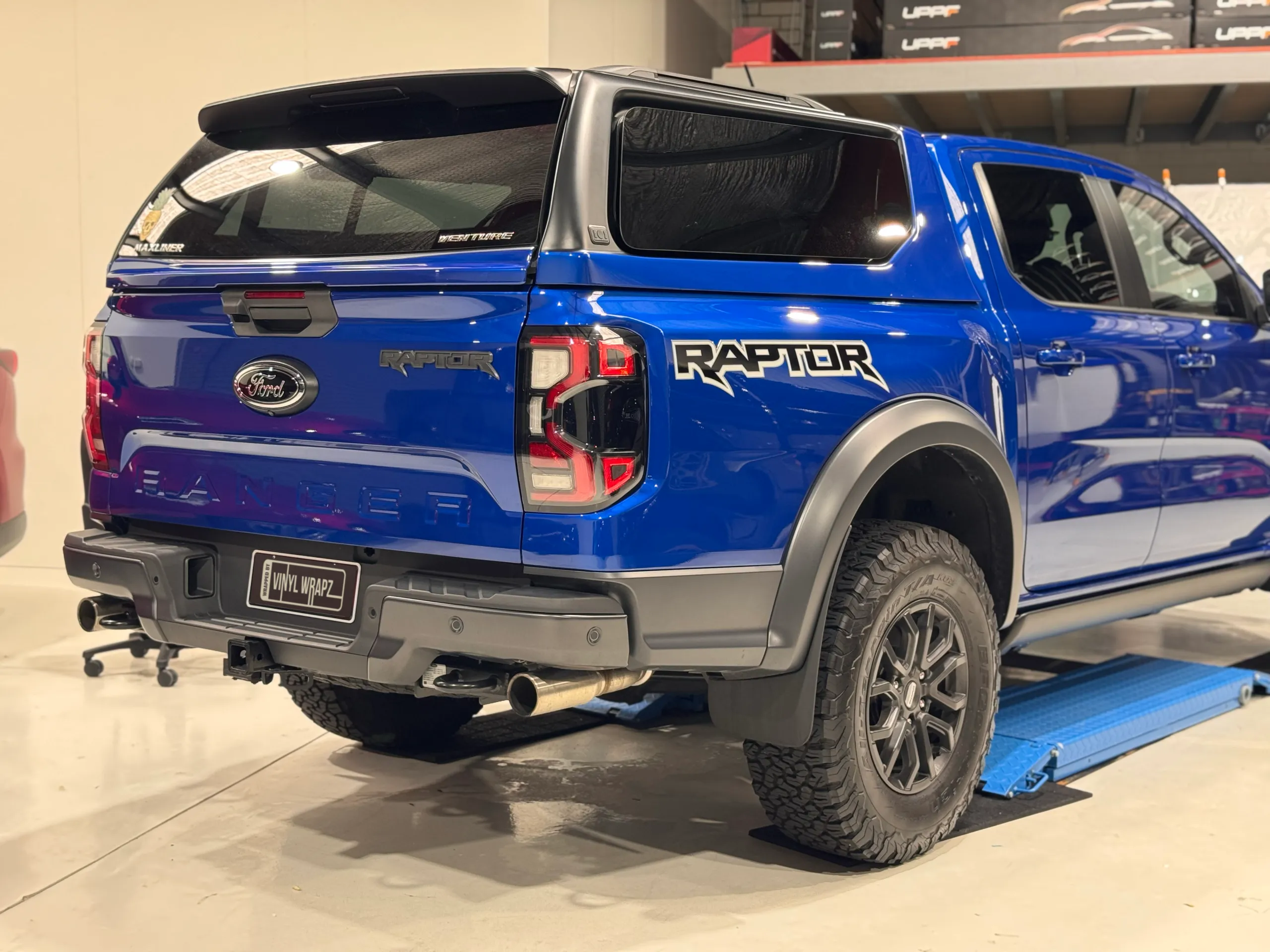 Blue Ford Ranger Raptor tailgate, rear wheel and canopy in the workshop