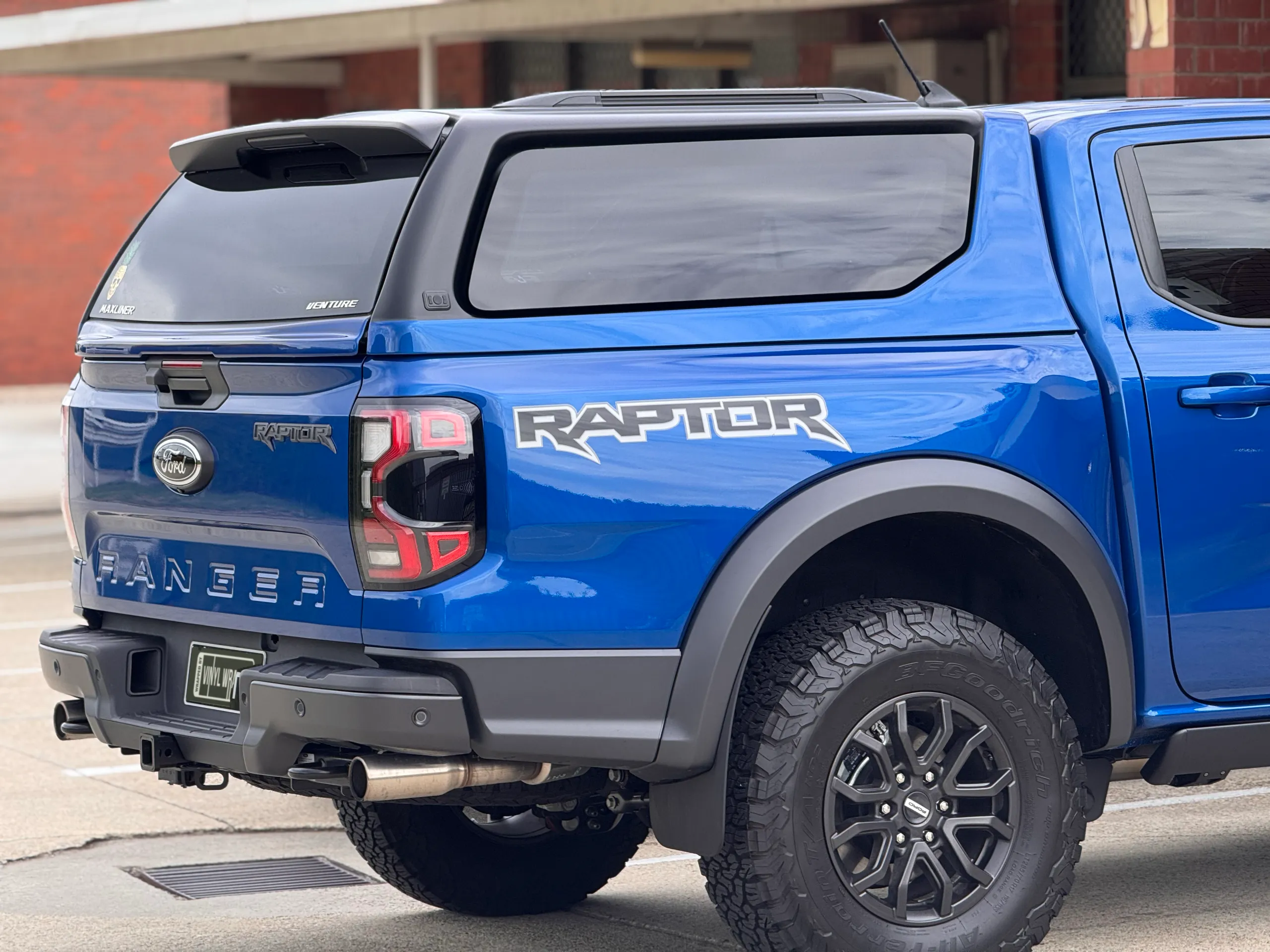 Blue Ford Ranger Raptor tailgate and canopy outside beside the workshop