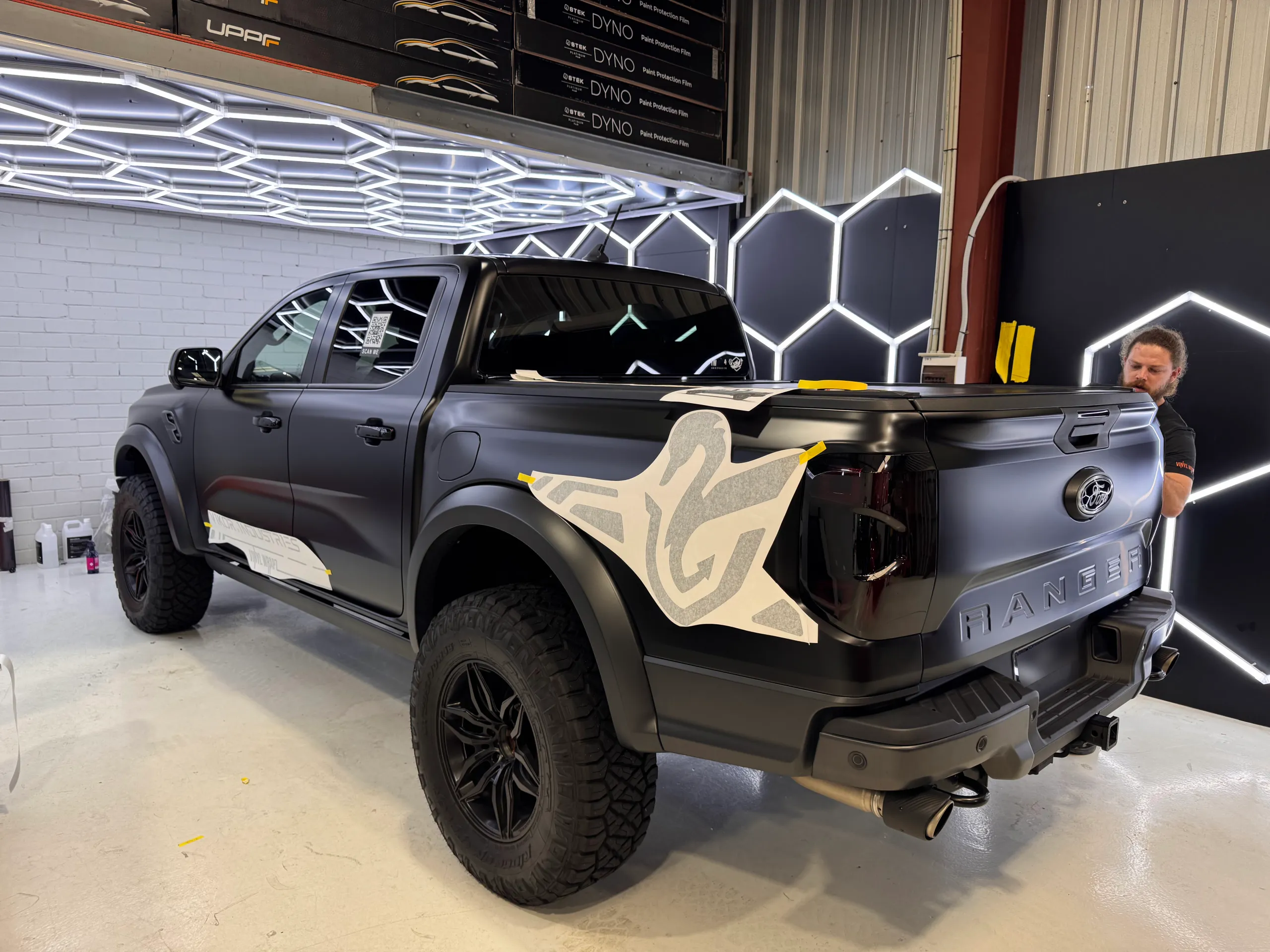 Ranger Raptor during installation, with rear lights removed and graphic backing still attached