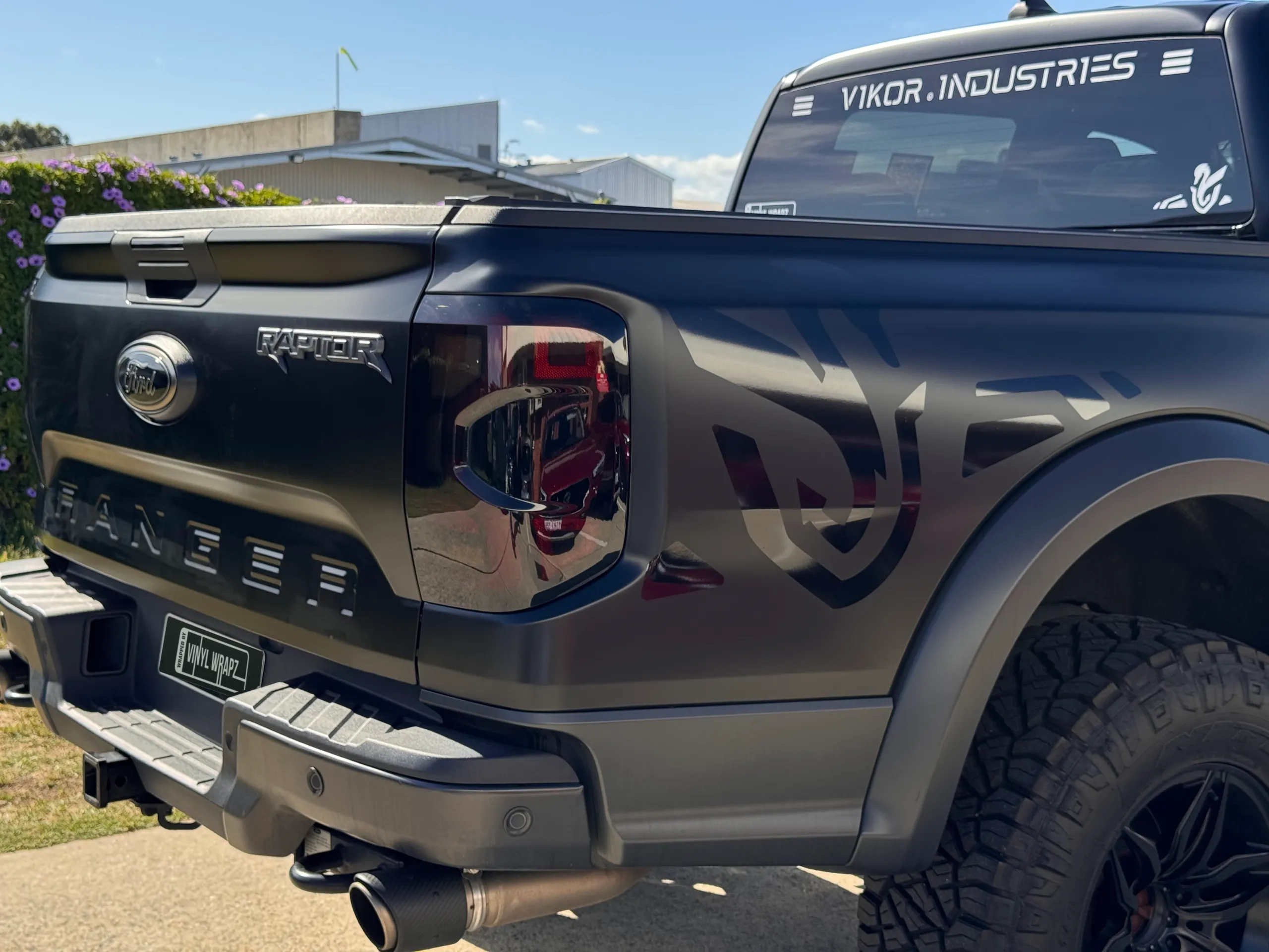 Ranger Raptor tailgate and rear-quarter graphic beneath Vikor Industries rear-window lettering