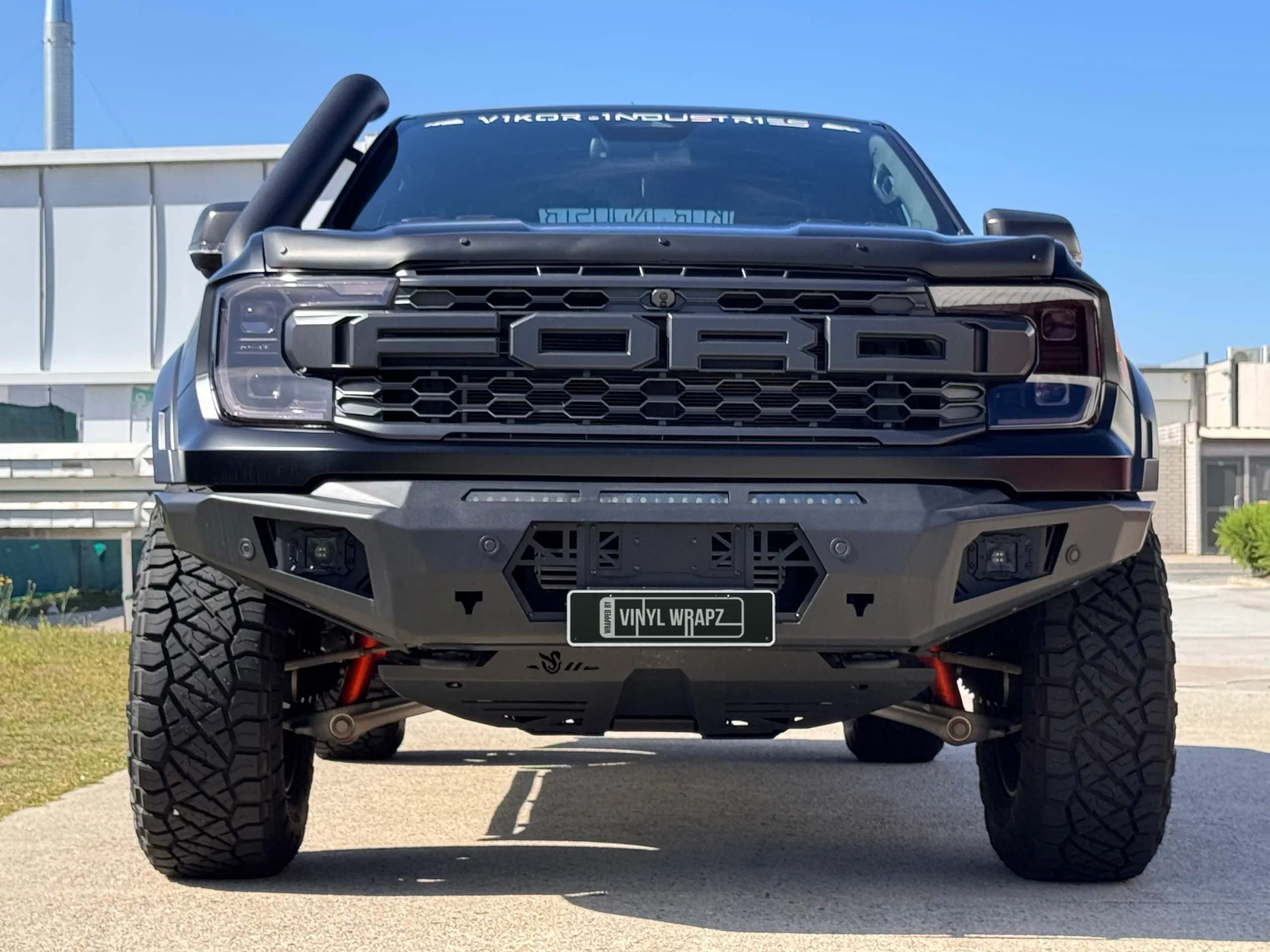 Head-on view of the satin grey Ranger Raptor with a snorkel and off-road bumper