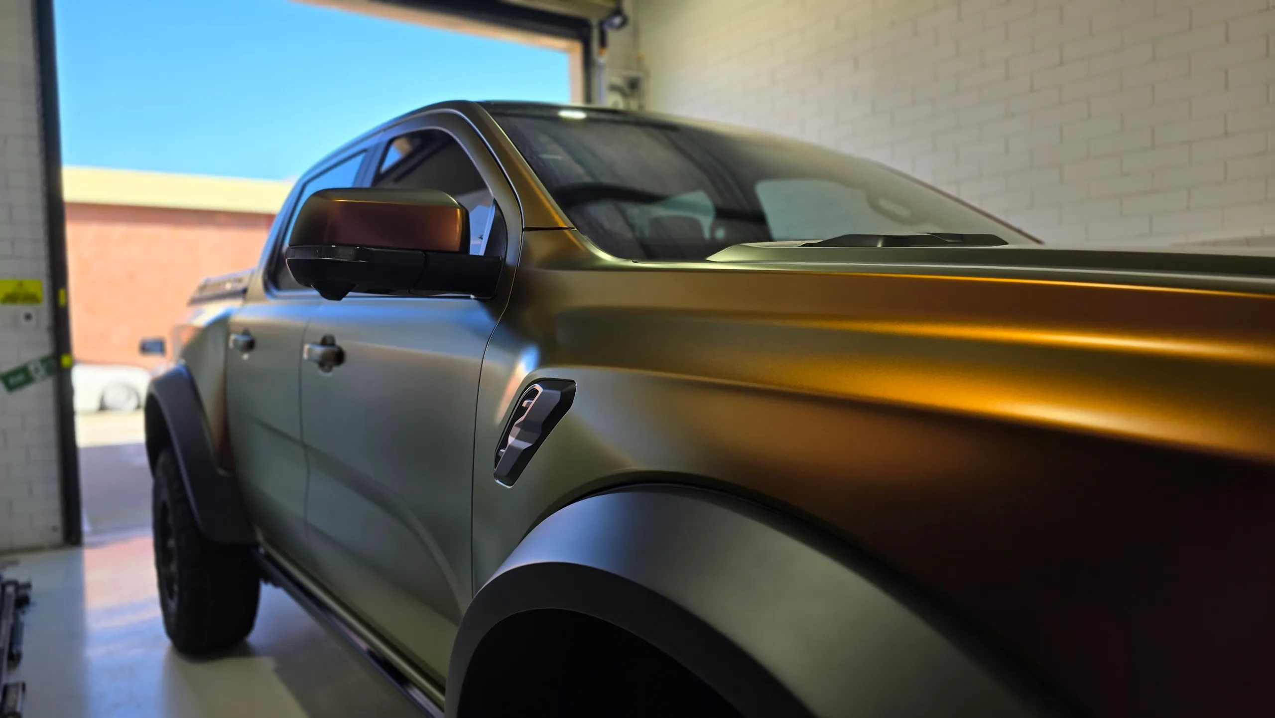 Satin colour-shift finish on the Ford Ranger Raptor front guard, doors and mirror in the workshop