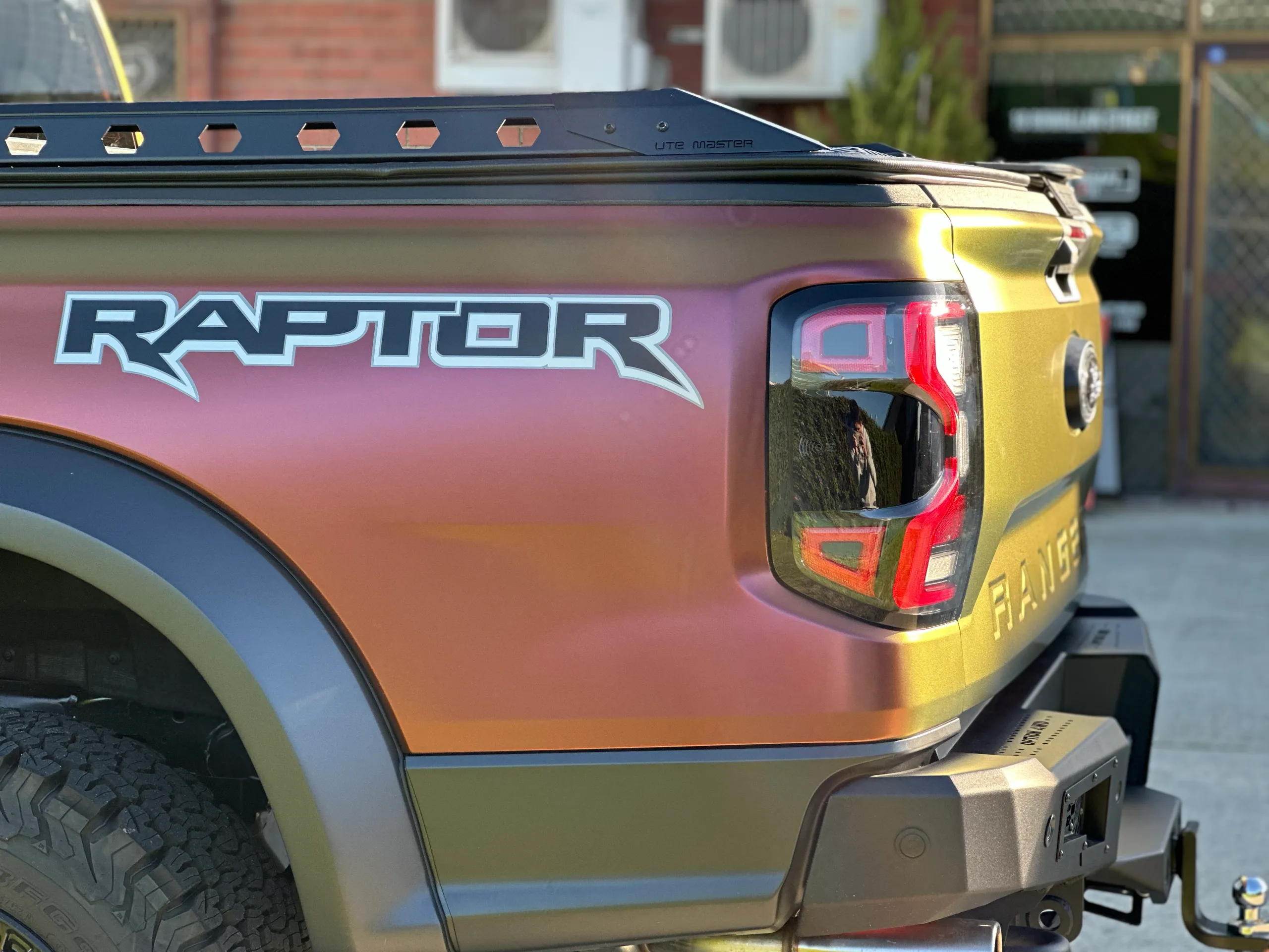 Raptor lettering beside the rear light on the colour-shift Ford Ranger ute
