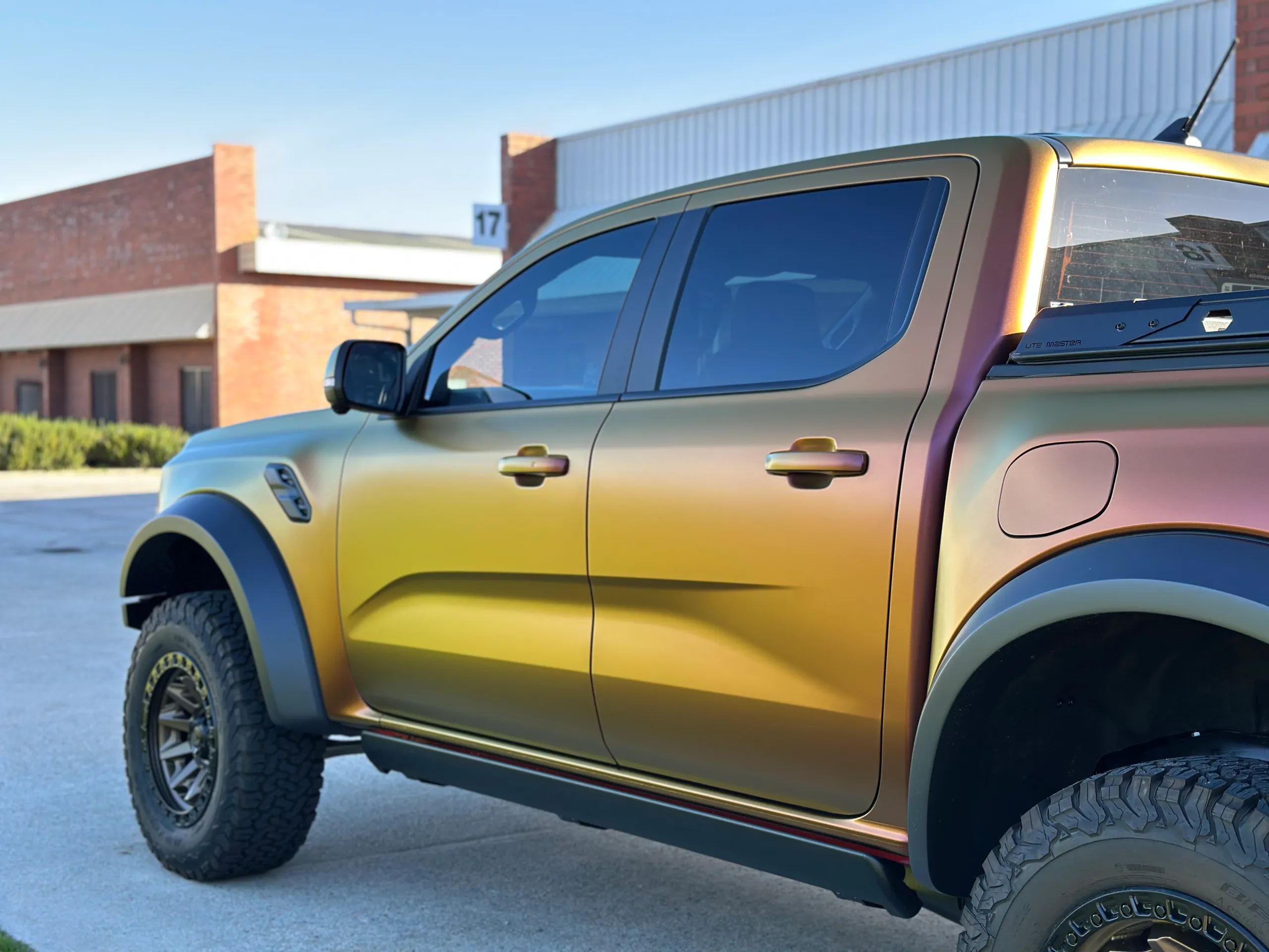 Gold and green colour-shift finish across the Ford Ranger Raptor doors outdoors