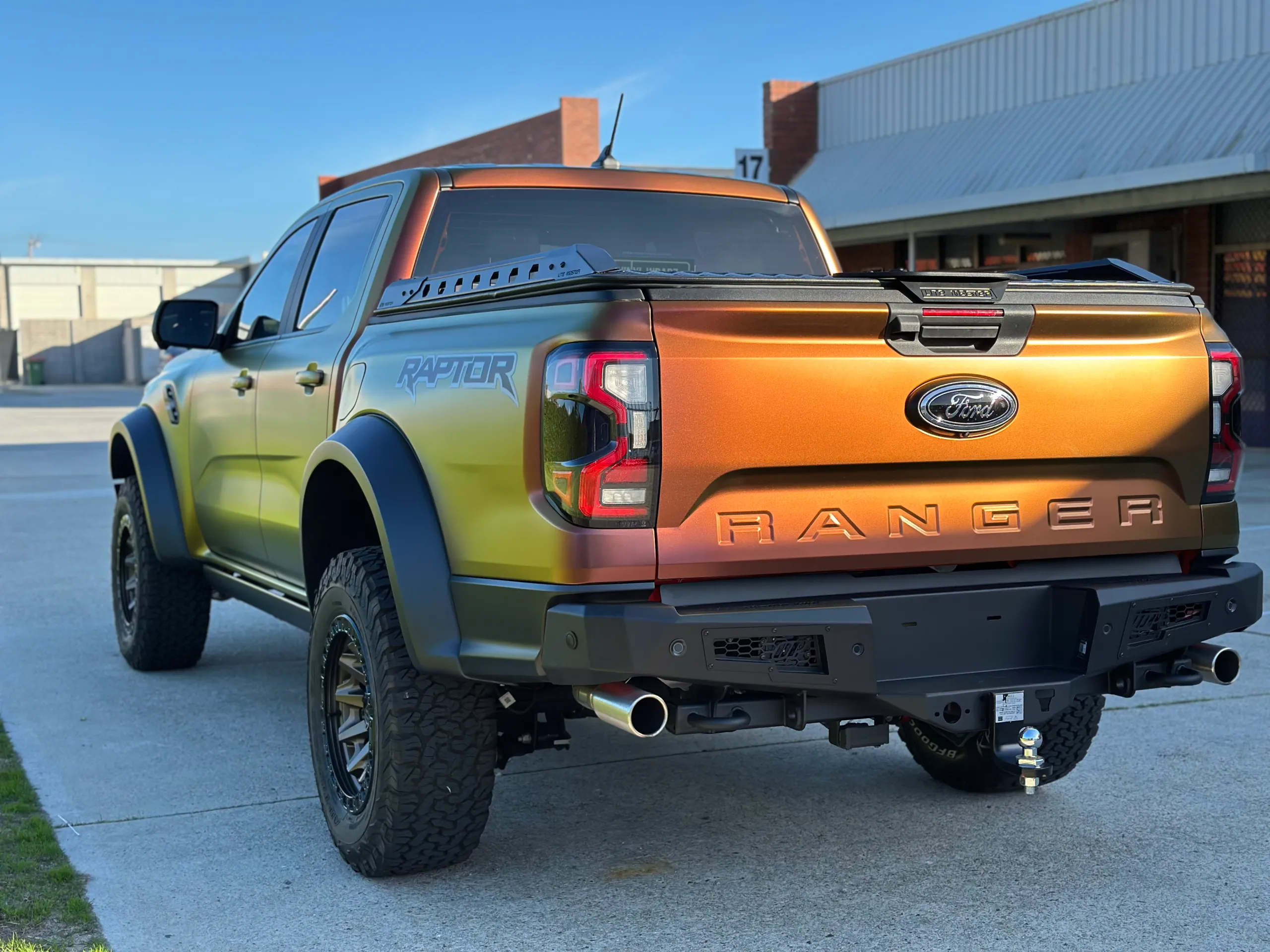 Rear-quarter view of the Ford Ranger Raptor showing gold and copper tones across the tailgate