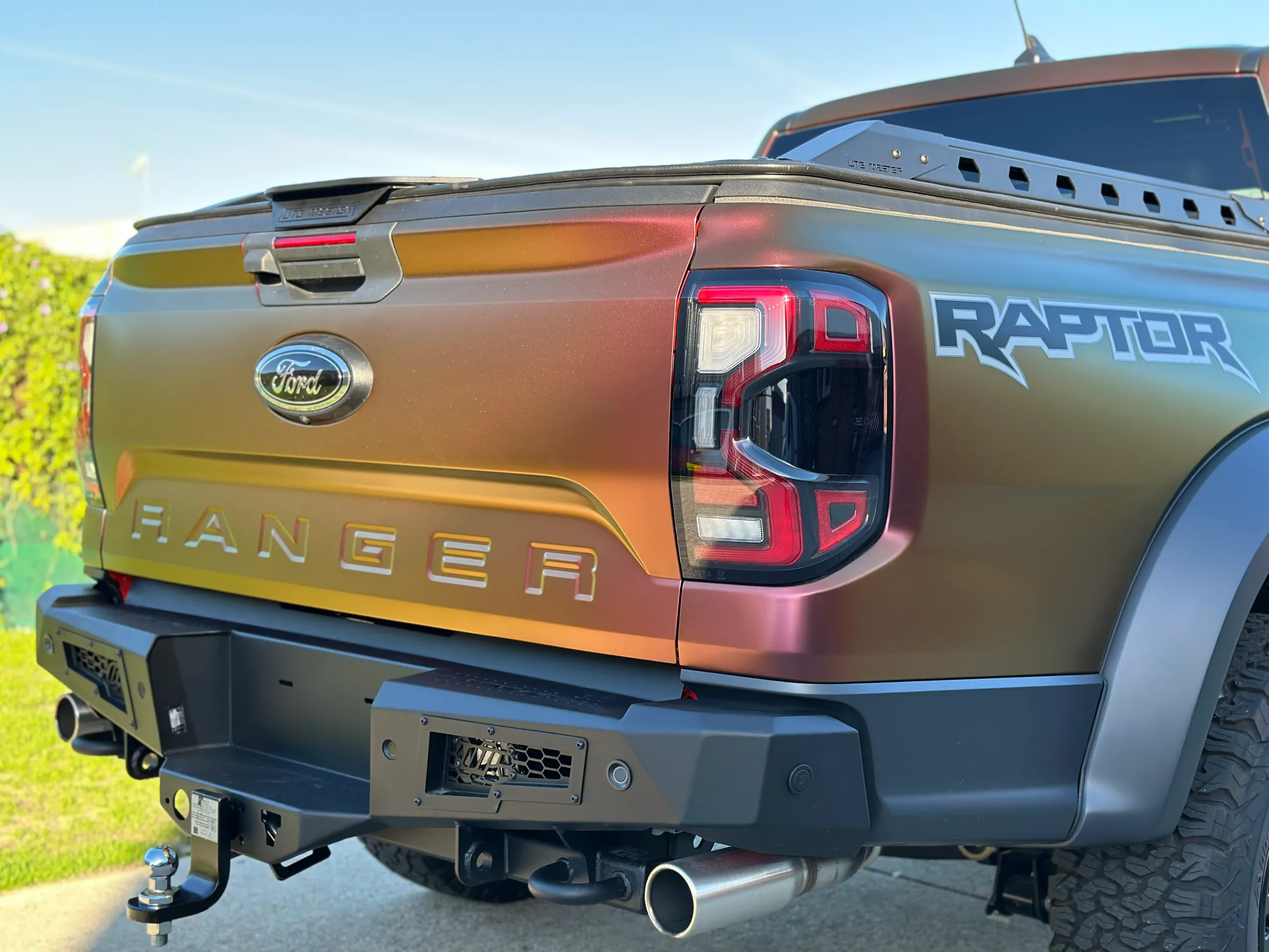Ford Ranger Raptor tailgate, rear light and black bumper beneath a colour-shift finish
