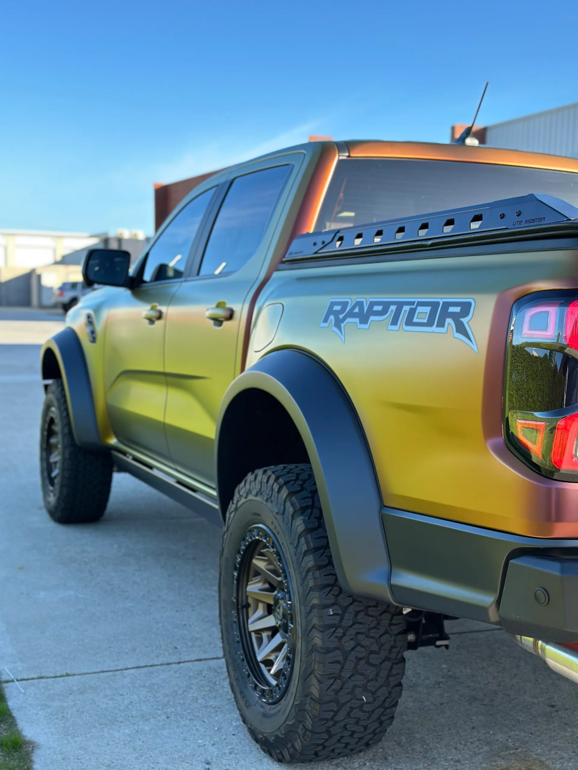 Low view along the colour-shift Ford Ranger Raptor rear quarter and doors