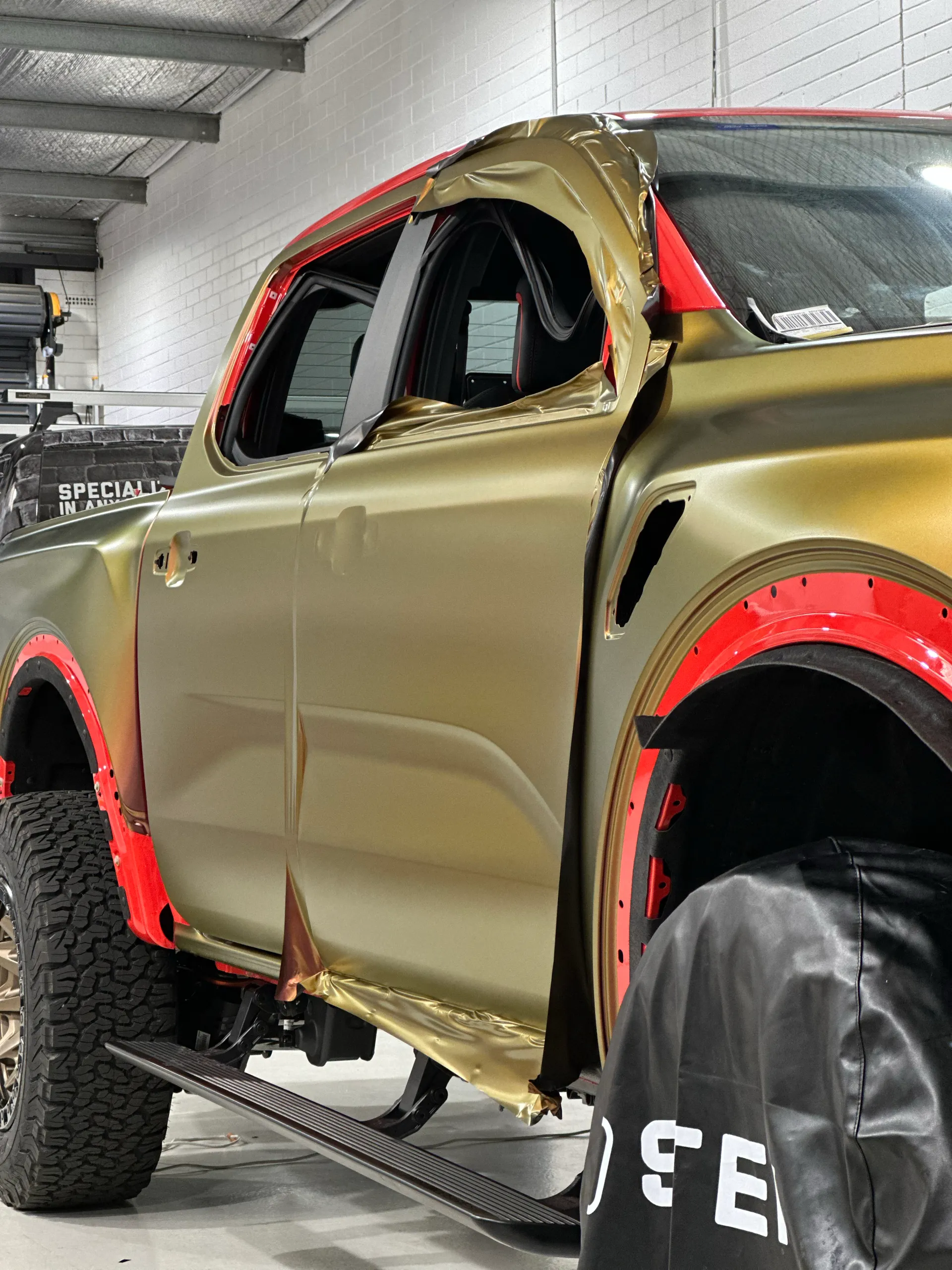 Ford Ranger Raptor doors during wrapping with loose film around the window frames and sills