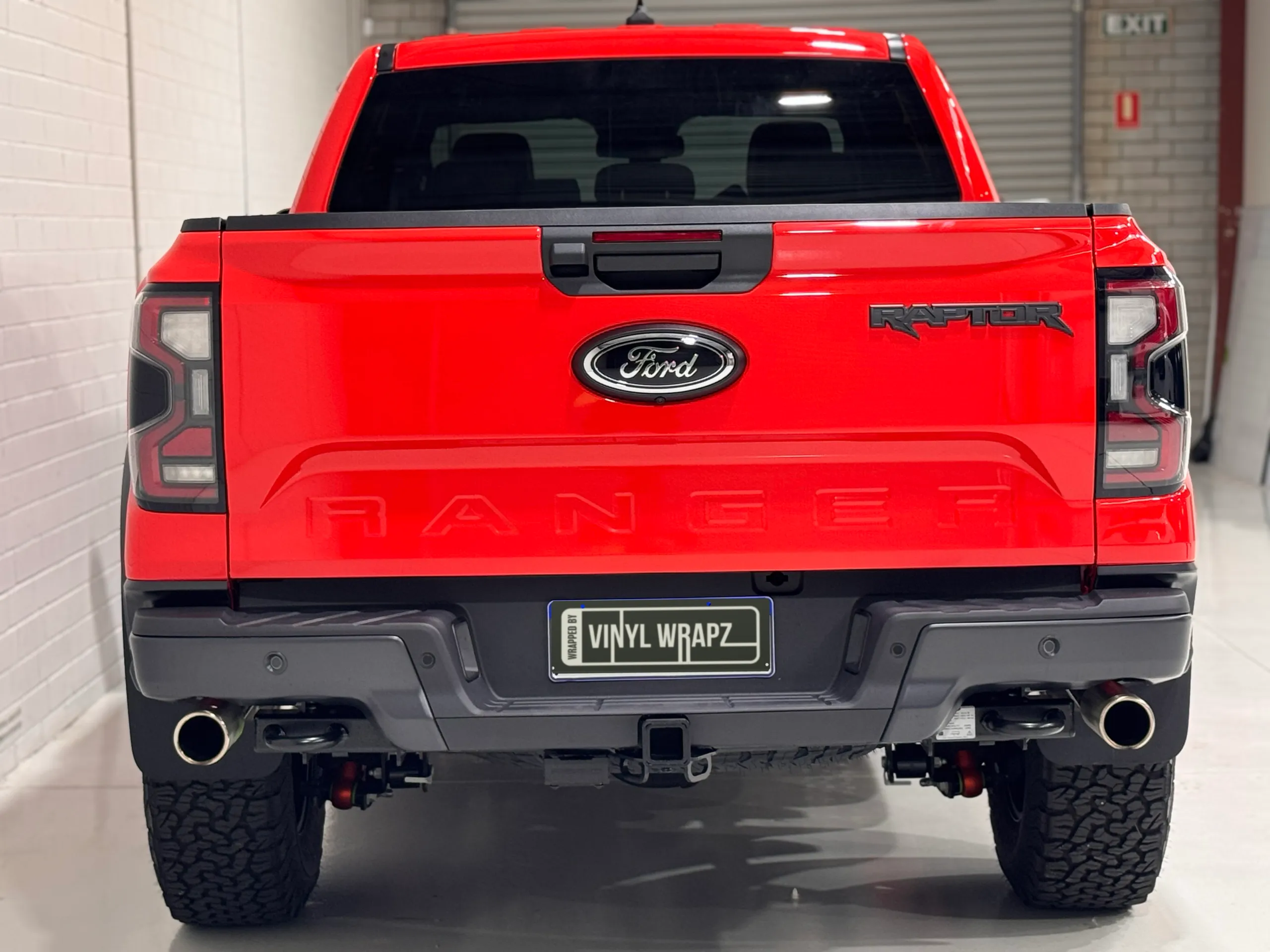 Rear view of the gloss red Ford Ranger Raptor in the workshop