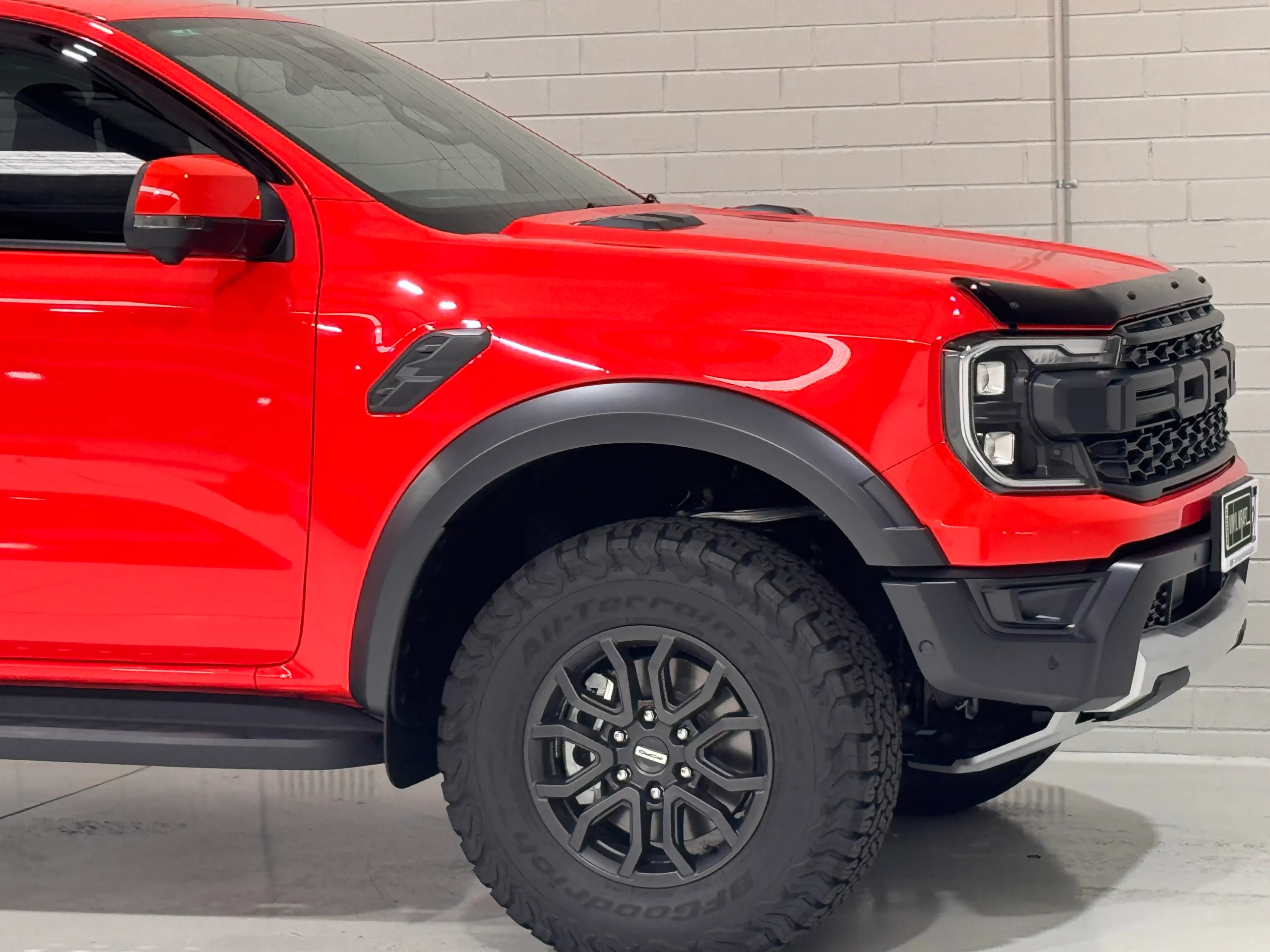 Red Ford Ranger Raptor front guard and black wheel-arch trim