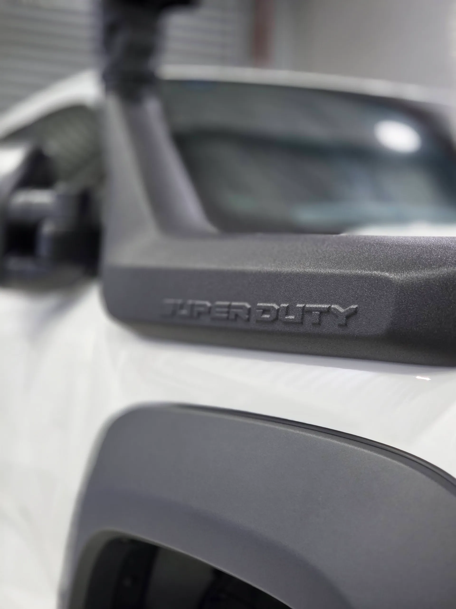 Super Duty lettering on the snorkel beside the white Ranger bonnet