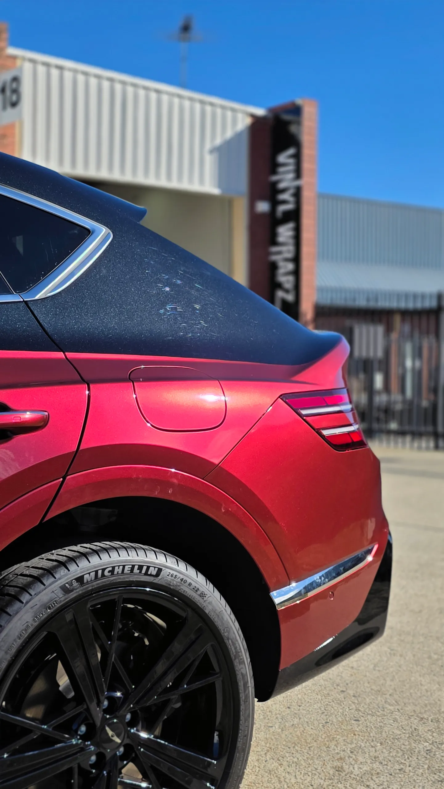Red Genesis GV80 Coupe rear quarter beneath its black roof and rear pillar
