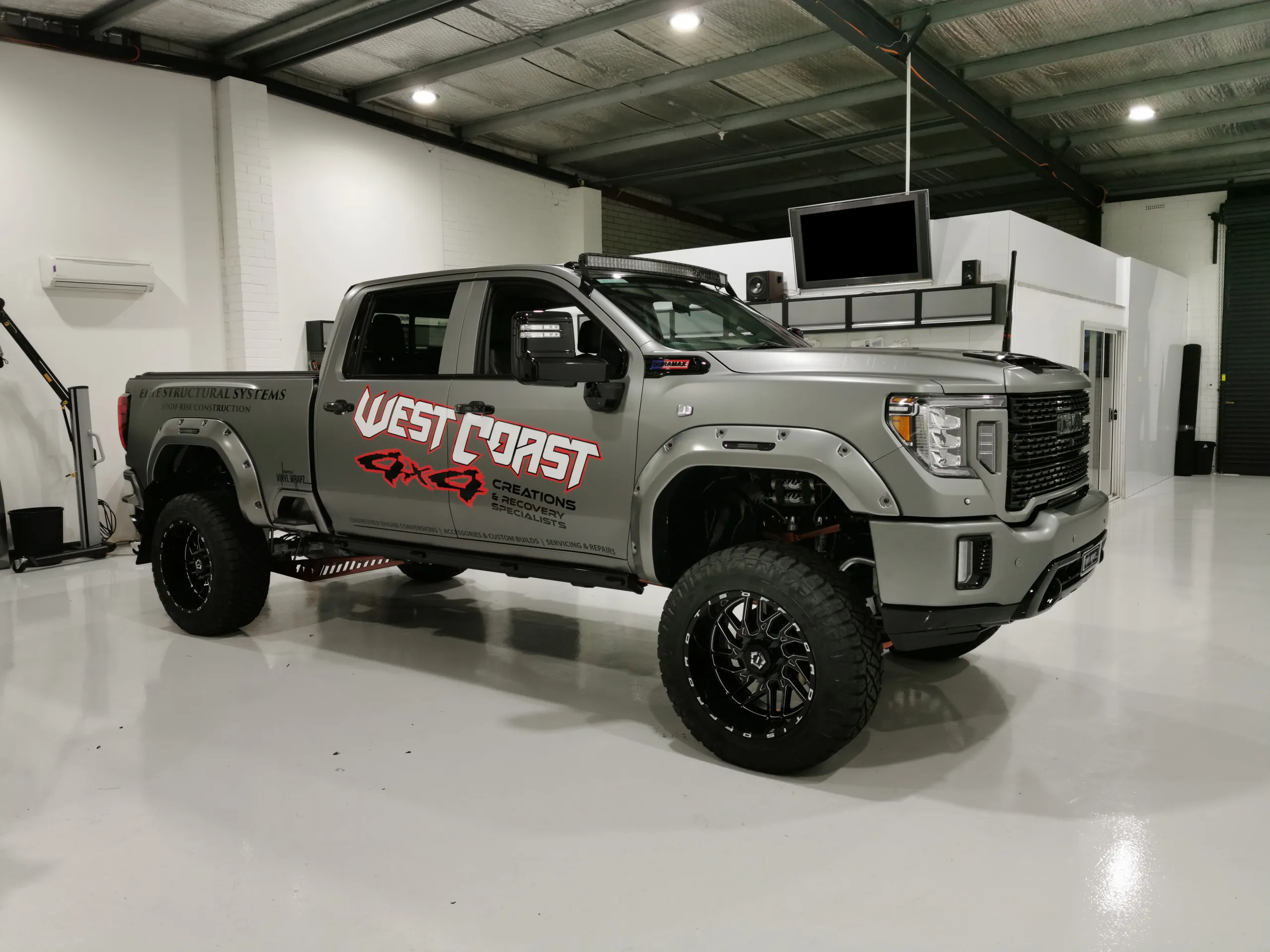 Satin grey GMC Sierra Denali with West Coast 4x4 graphics on its doors