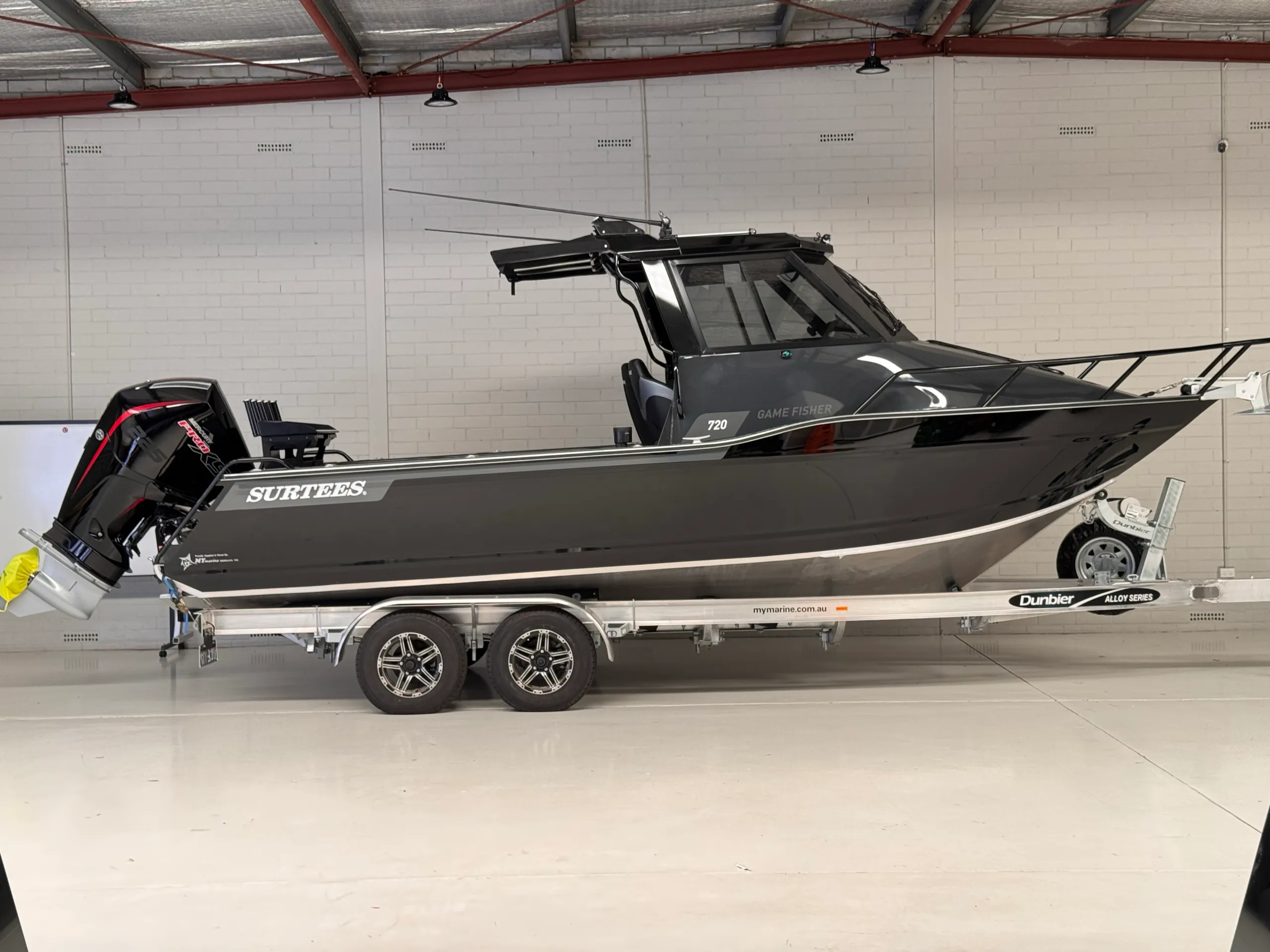 Dark grey Surtees 720 Game Fisher on a tandem-axle trailer in the workshop