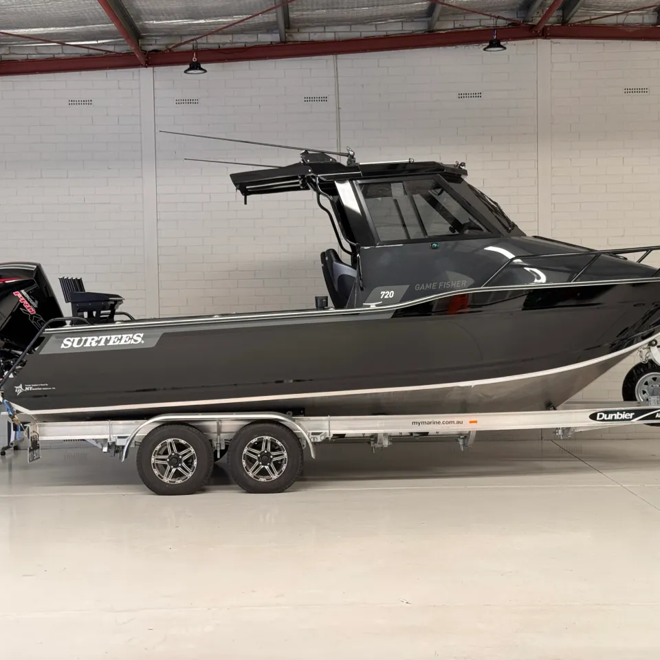 Dark grey Surtees 720 Game Fisher on a tandem-axle trailer in the workshop