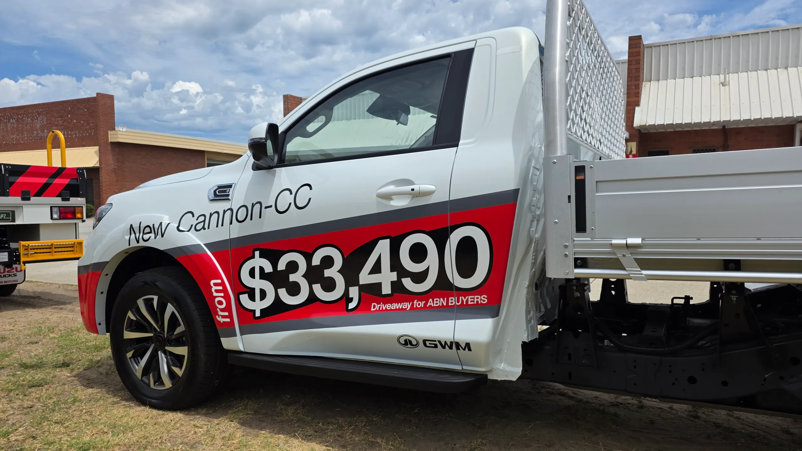GWM Cannon single-cab ute with red and grey promotional graphics across its door and front guard
