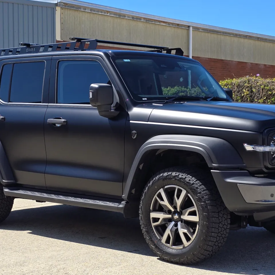 Satin black GWM Tank 300 viewed from the front quarter outside the workshop