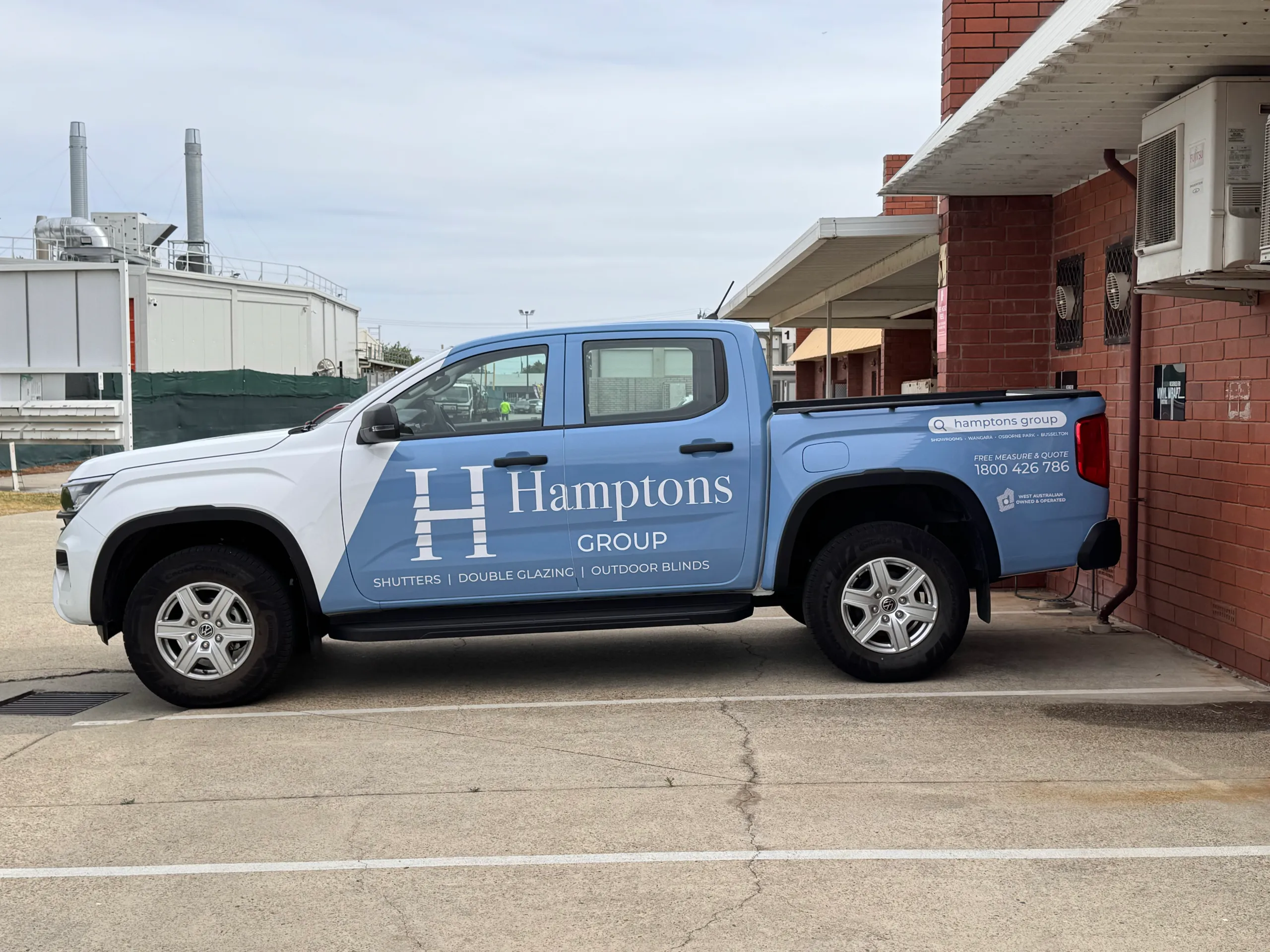 Blue and white Hamptons Group Volkswagen Amarok parked beside the workshop
