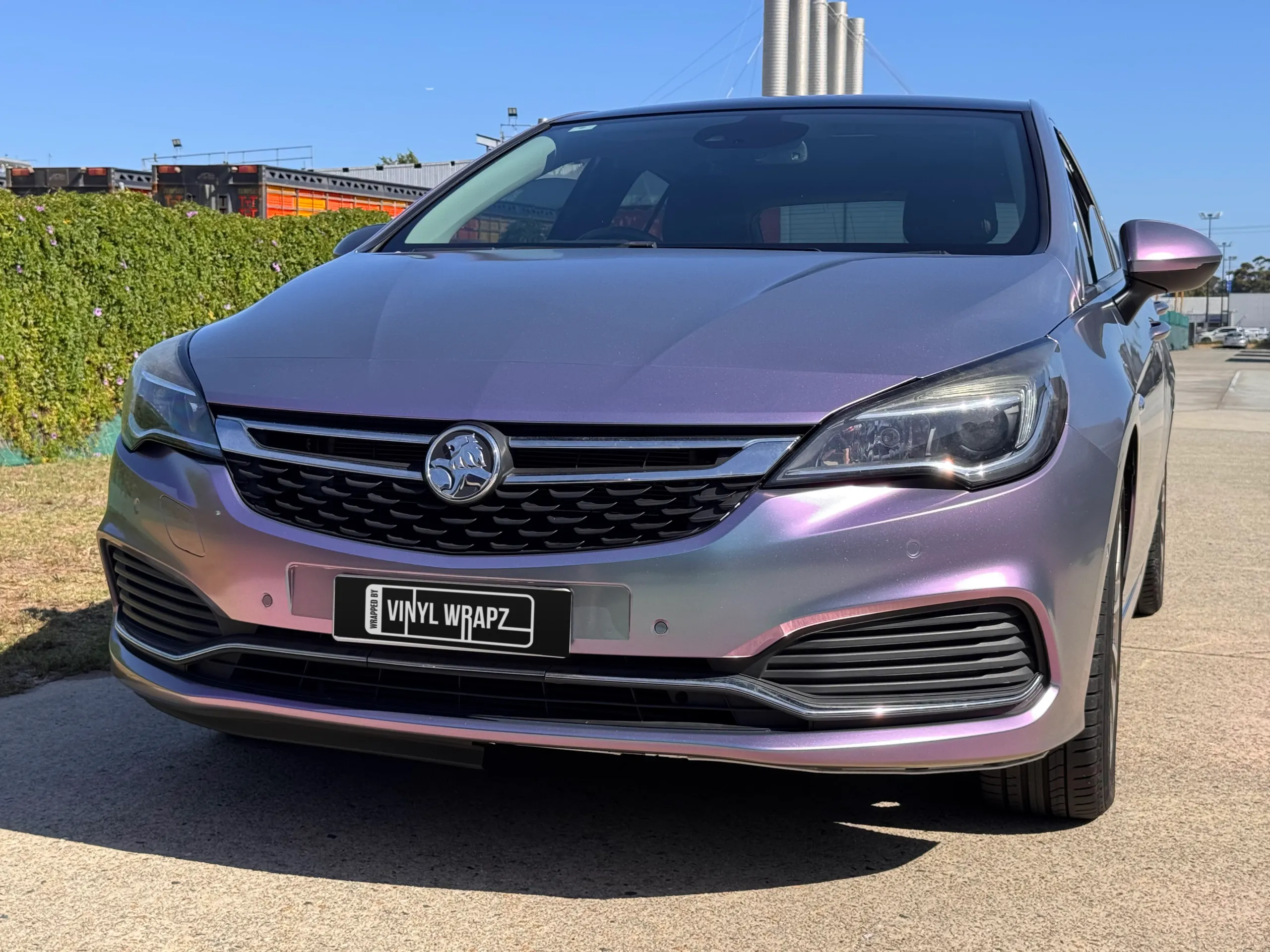 Lavender colour-shift Holden Astra hatchback outside the workshop, front