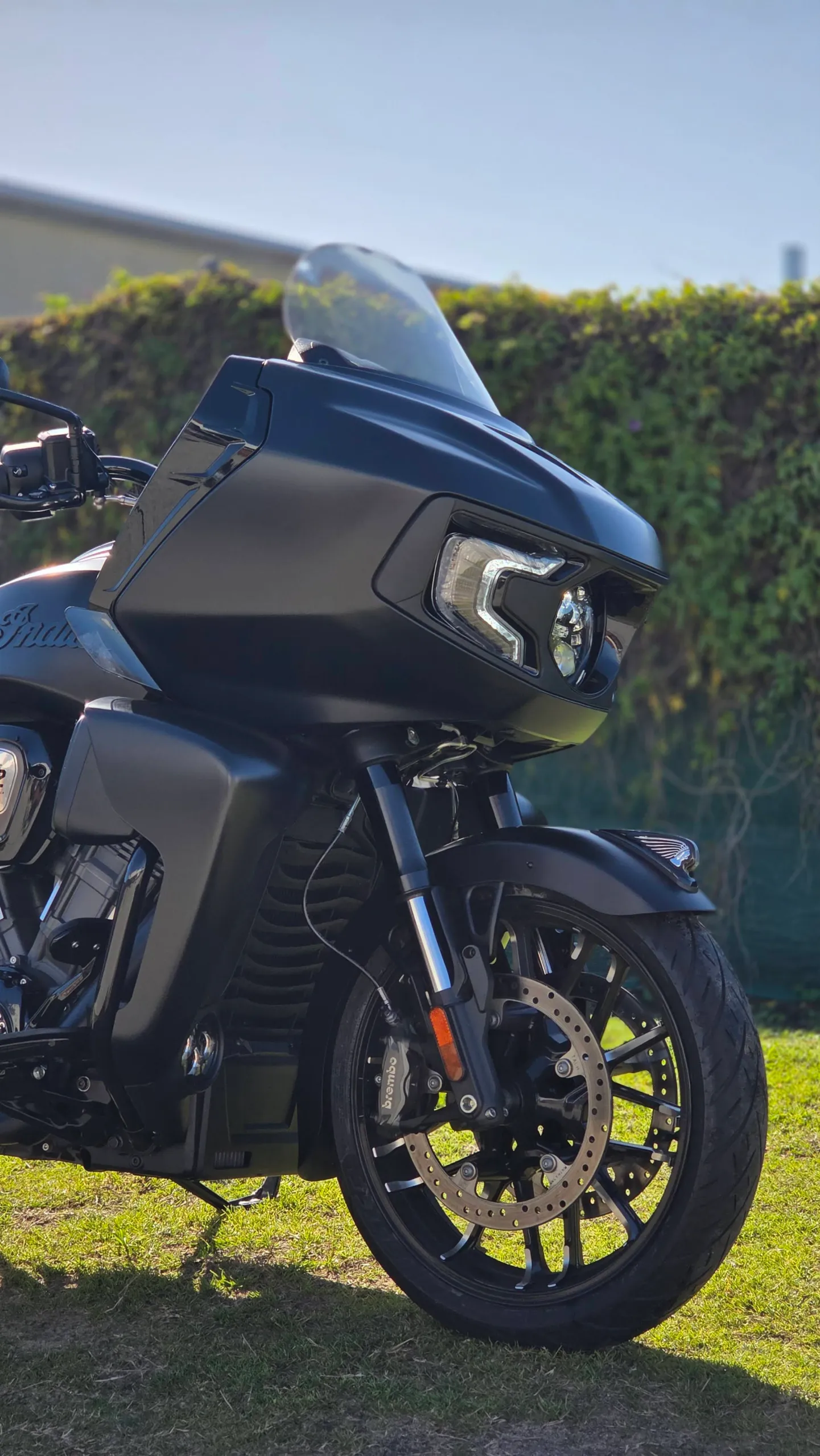Matte black Indian Pursuit front fairing, headlight and wheel outdoors