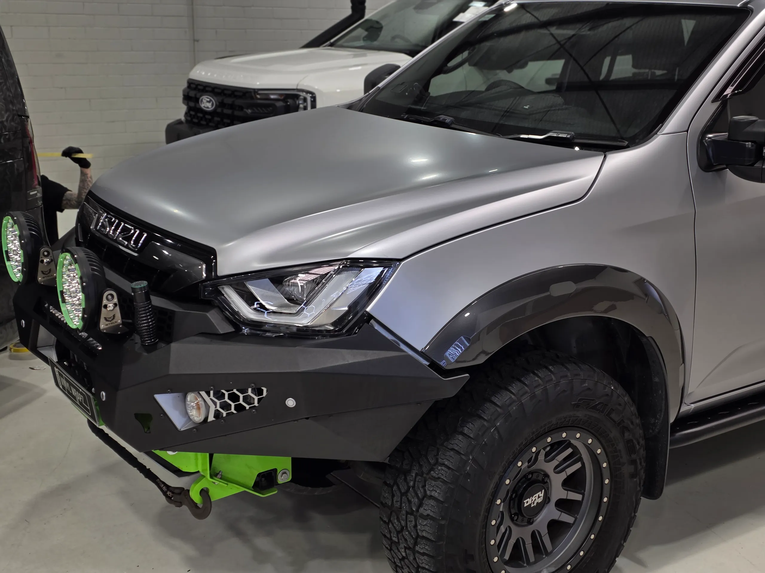 Satin silver Isuzu D-MAX bonnet and front guard above a black bull bar