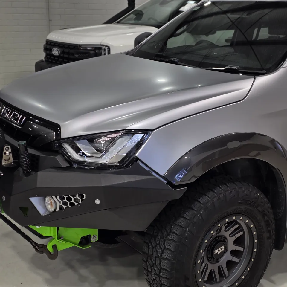 Satin silver Isuzu D-MAX bonnet and front guard above a black bull bar