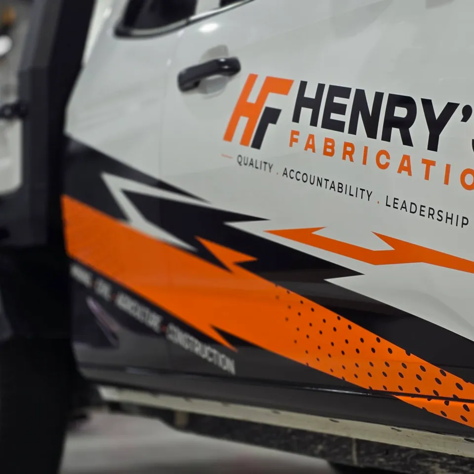 HF logo and angular orange and black graphics across the Isuzu ute doors
