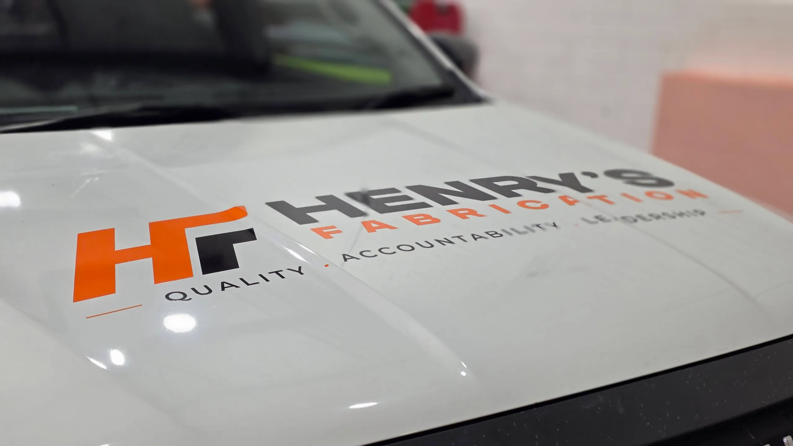 Henry’s Fabrication HF logo across the white Isuzu D-MAX bonnet