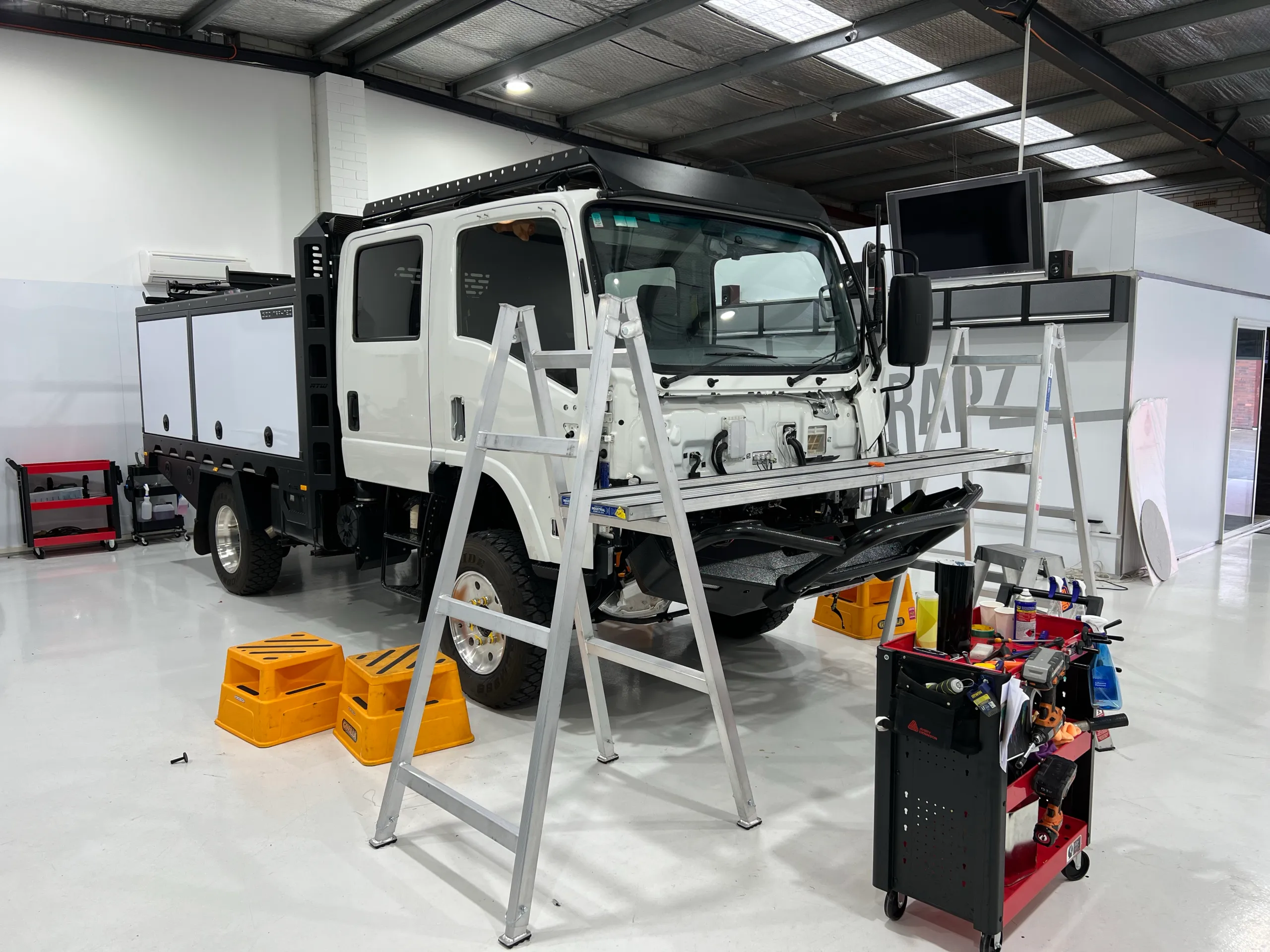 Isuzu truck in the workshop with front trim removed