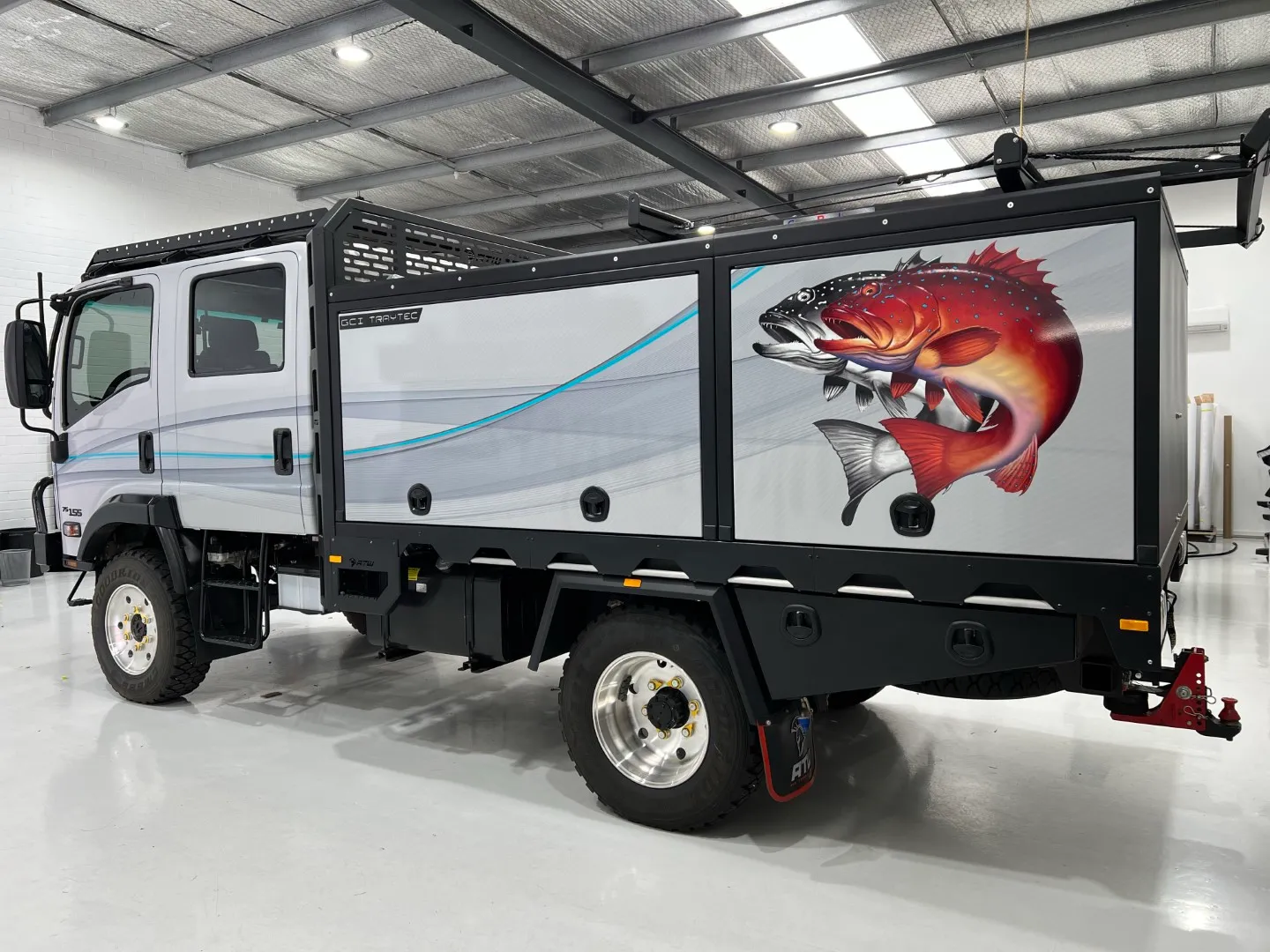 Fish graphic and rear body of the completed camper outdoors