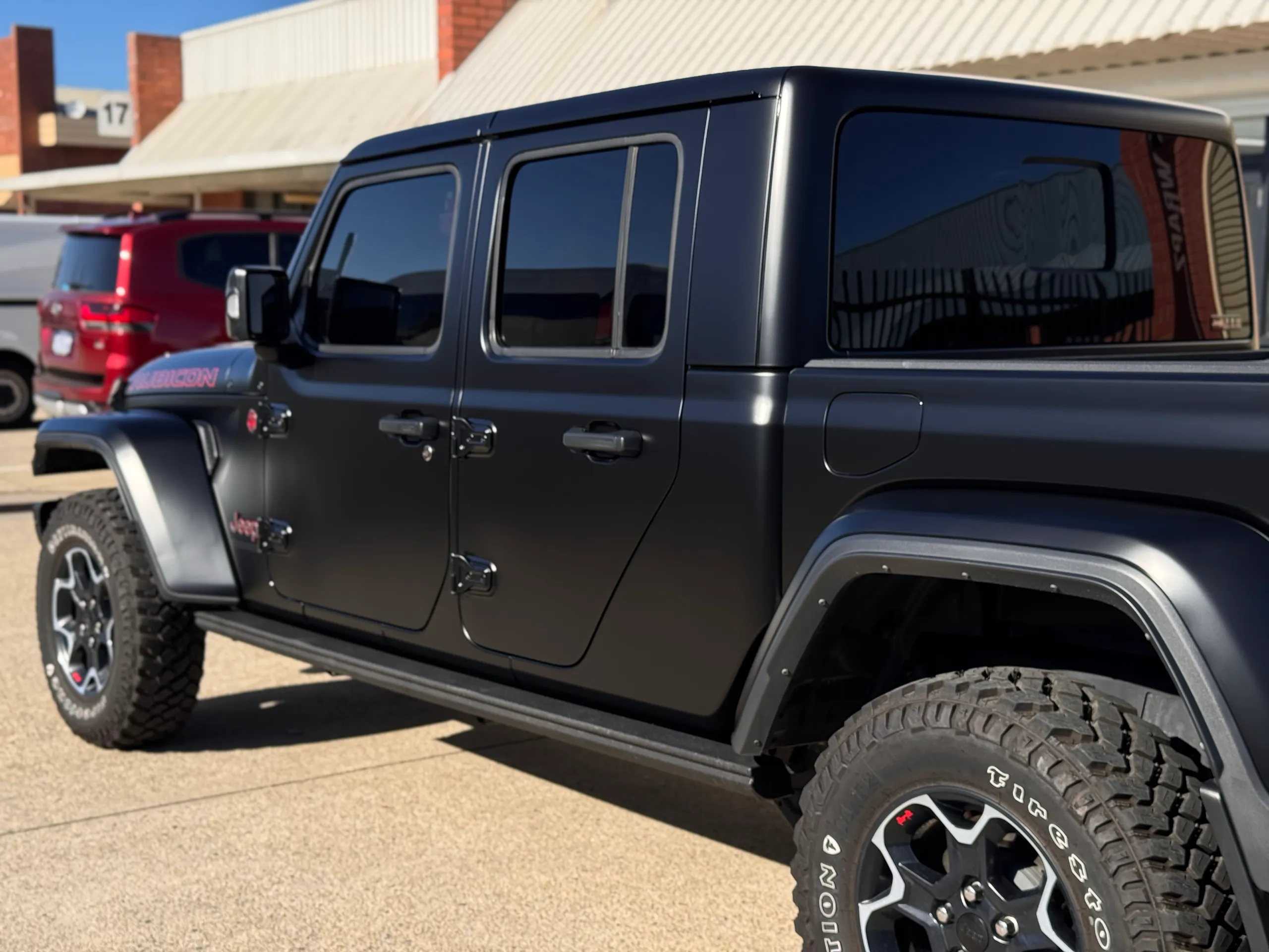 Matte black Jeep Gladiator Rubicon cab and doors in sunlight