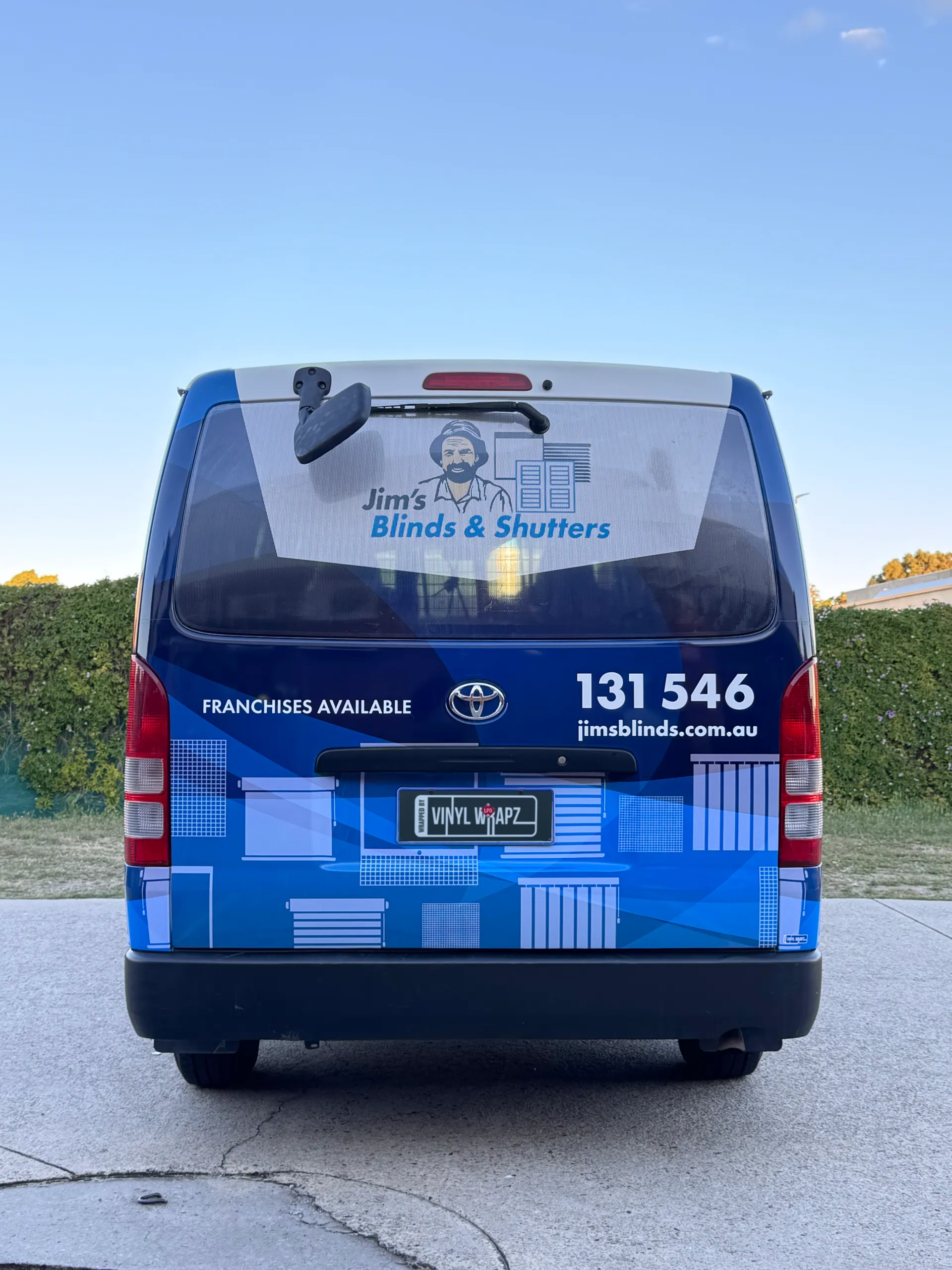 Rear view of the Toyota HiAce with Jim's Blinds & Shutters branding