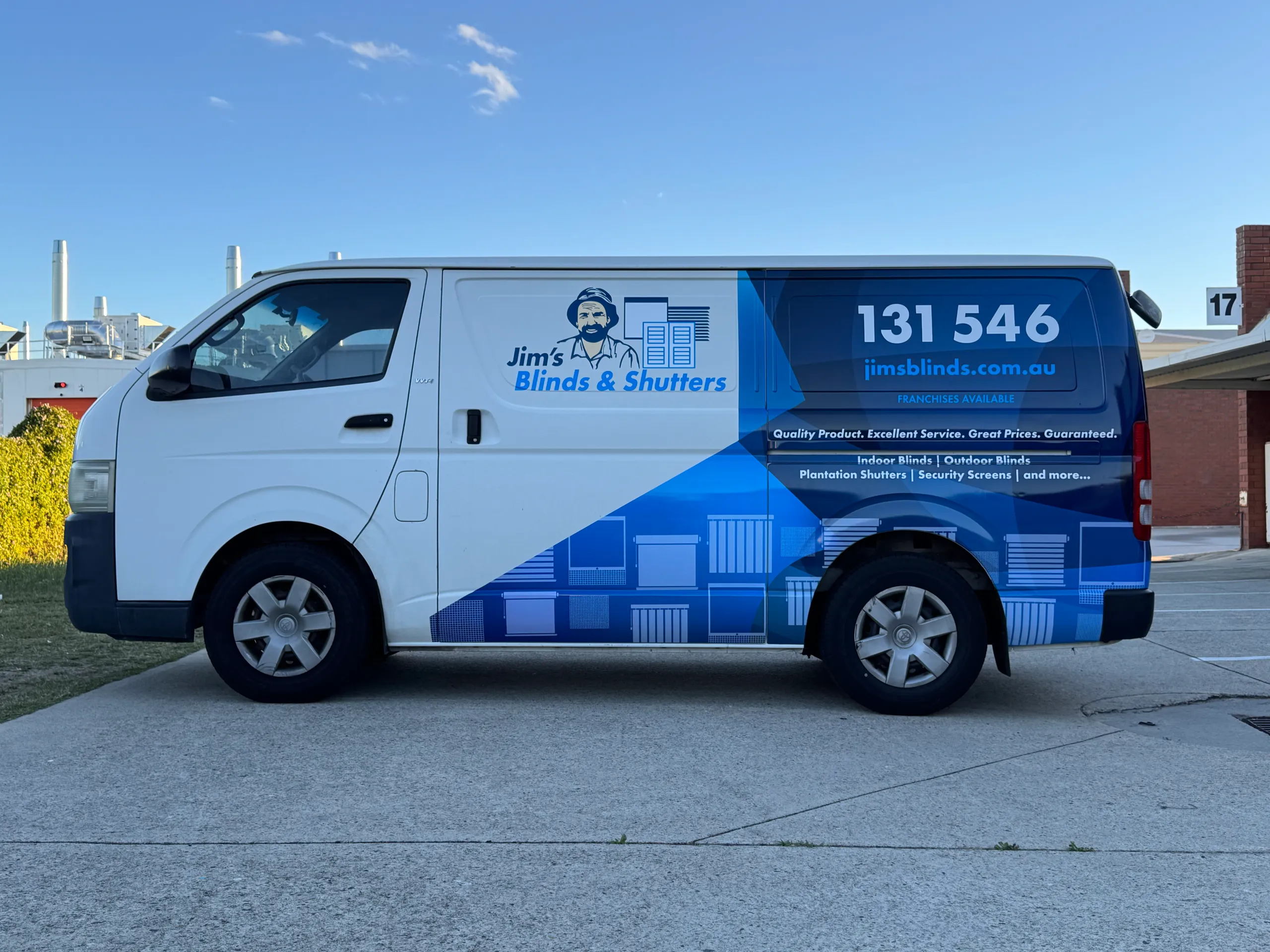 Side view of the white Toyota HiAce with blue Jim's Blinds & Shutters graphics
