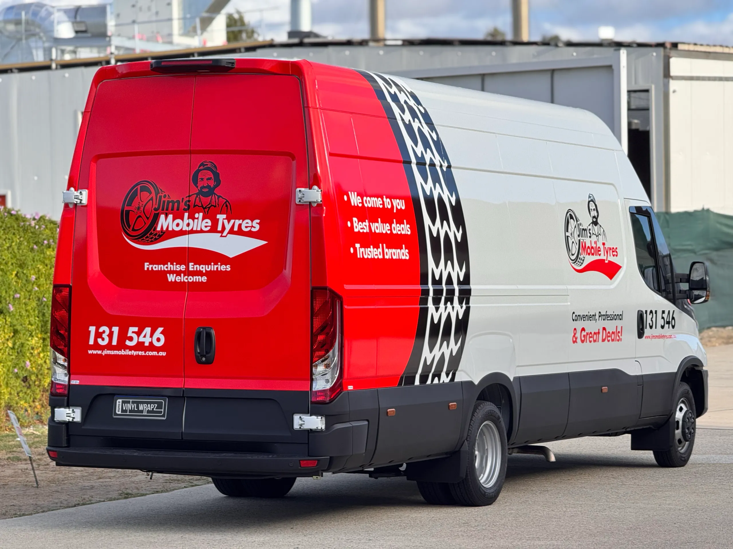 White Iveco Daily with Jim's Mobile Tyres graphics viewed from the rear quarter outdoors
