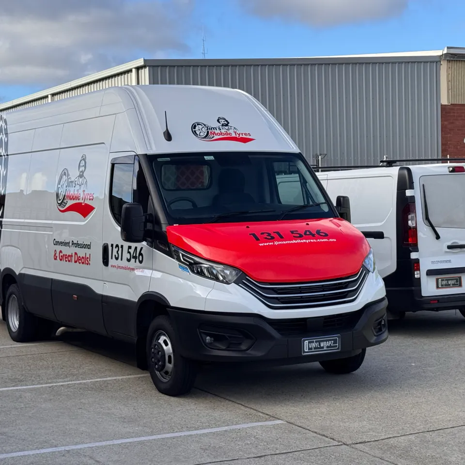 Jim's Mobile Tyres Iveco Daily viewed from the front quarter with its red branded bonnet