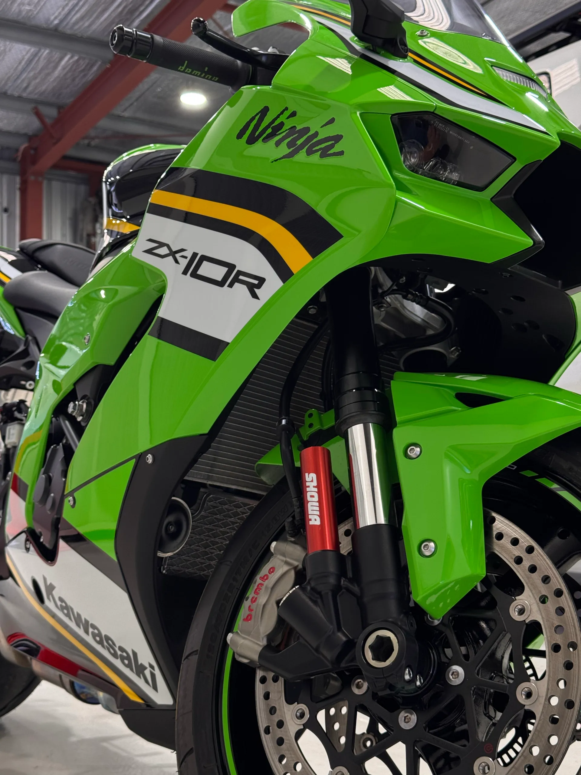 Low view of the green Kawasaki Ninja ZX-10R front fairing and wheel