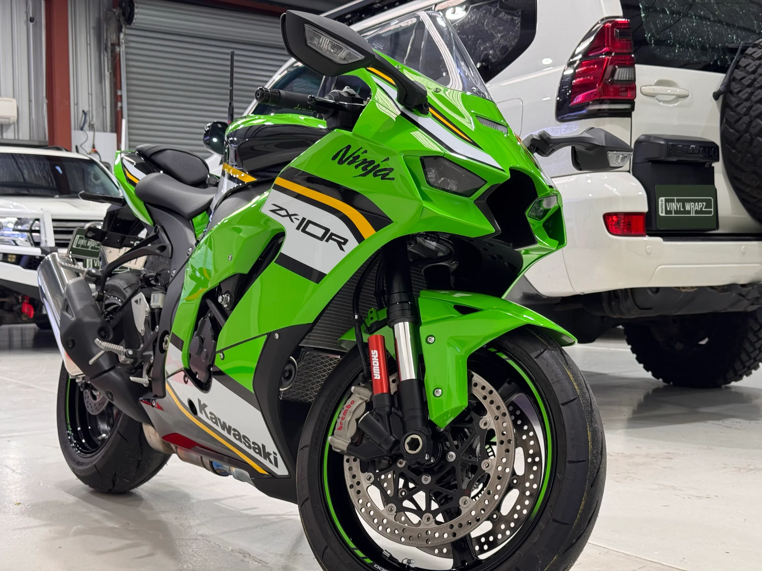 Green Kawasaki Ninja ZX-10R viewed from the front quarter inside the workshop
