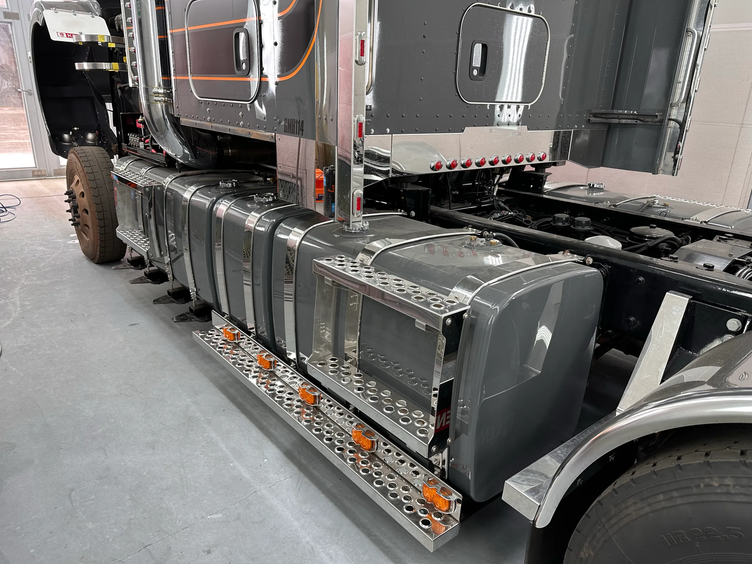 Grey Kenworth cab, chrome fuel tanks and perforated side steps in the workshop