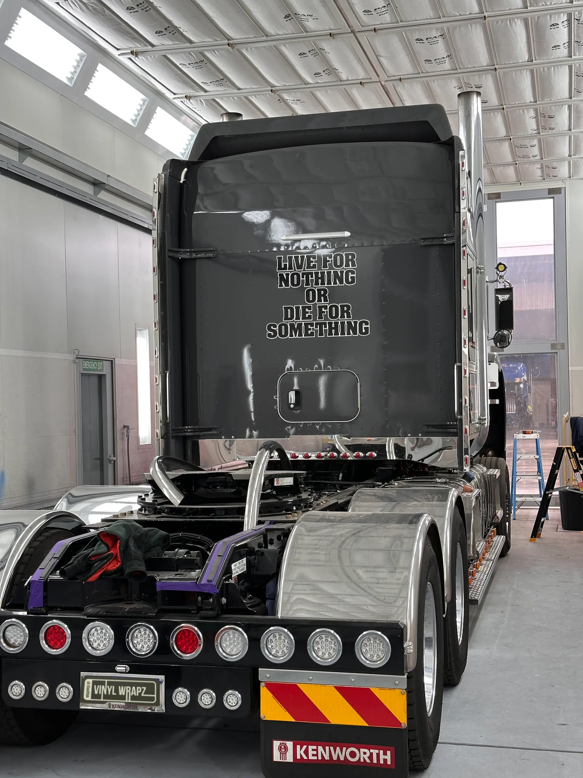 Grey Kenworth cab and rear chassis viewed from behind inside the workshop
