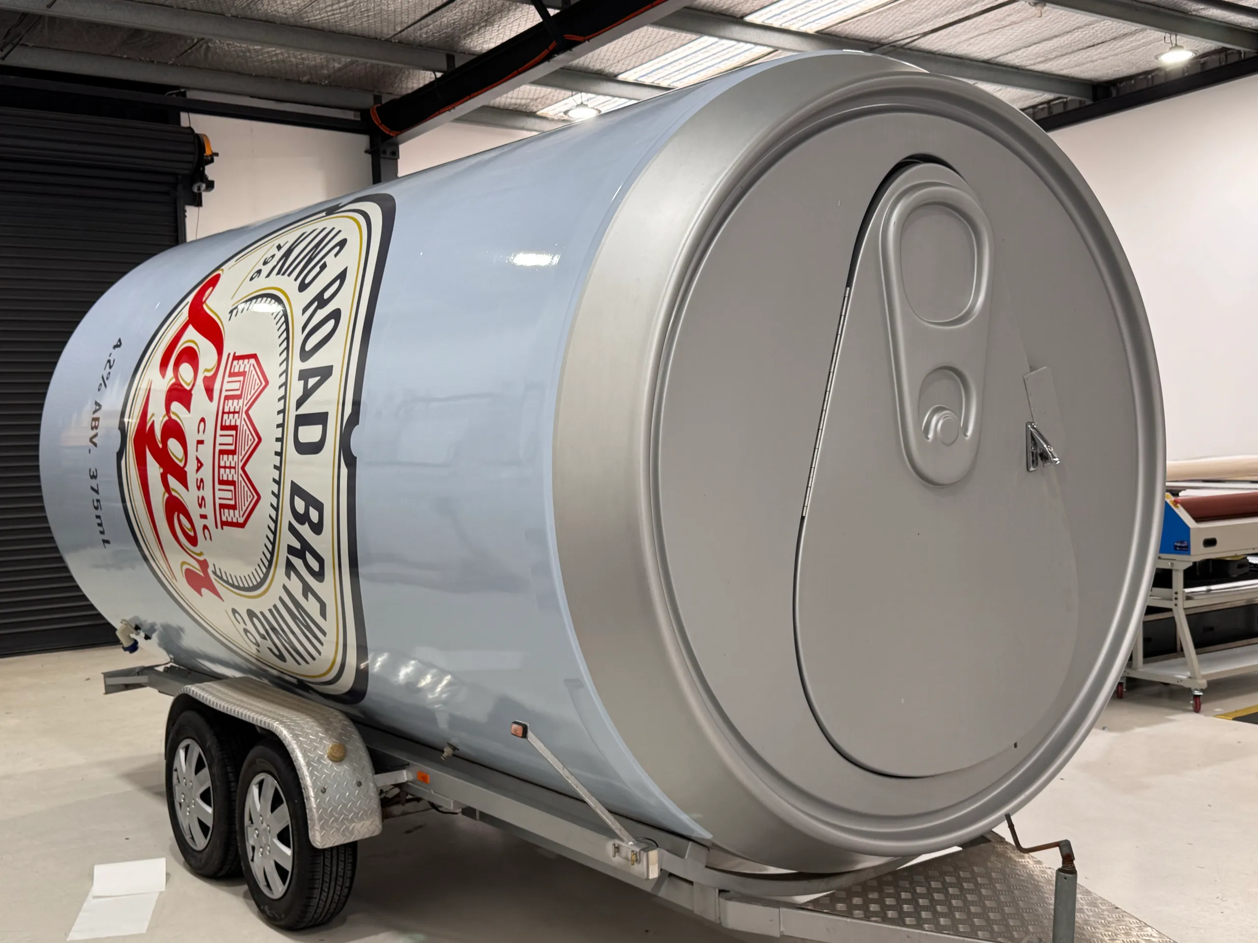 Silver can-lid detail at the front of the King Road Lager trailer
