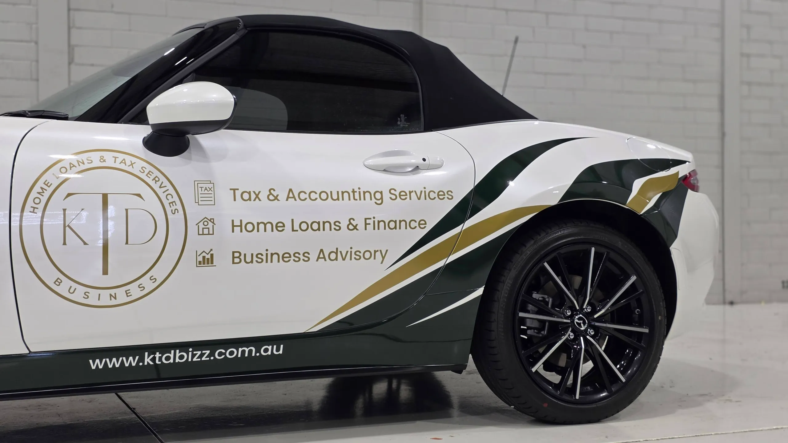 KTD logo and business services lettering on the white Mazda MX-5 door
