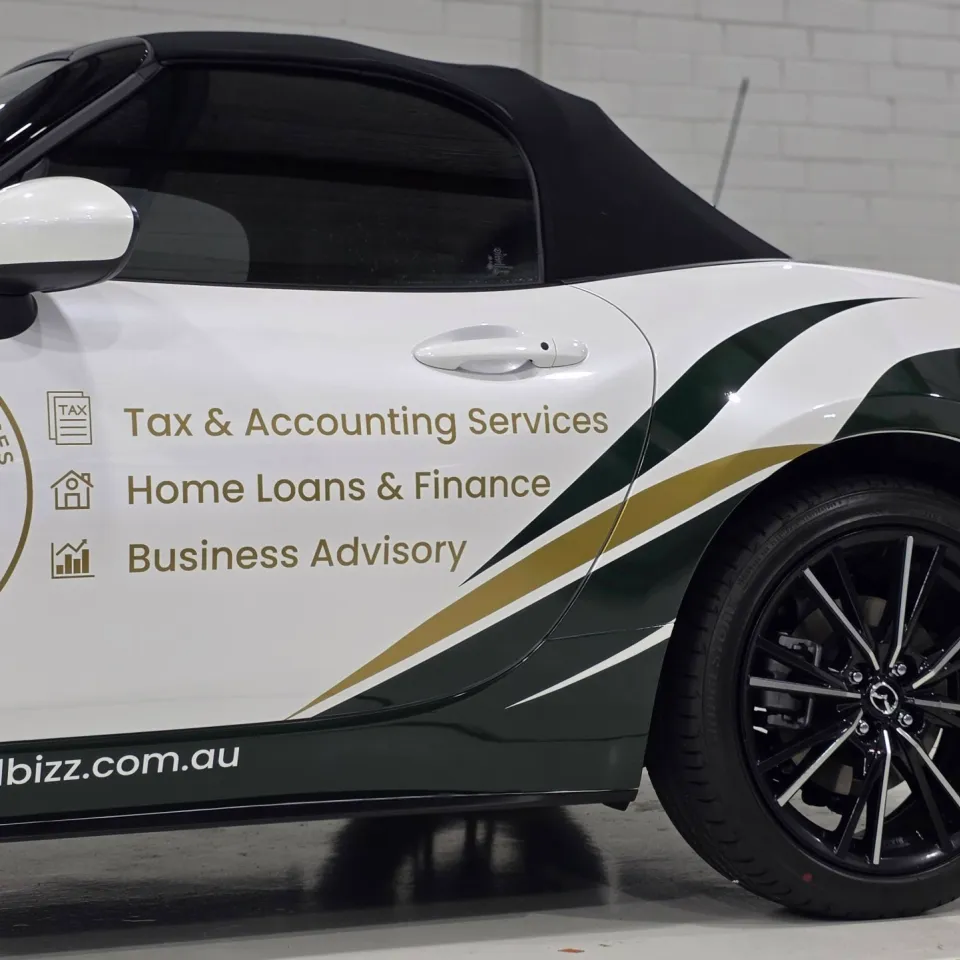 KTD logo and business services lettering on the white Mazda MX-5 door