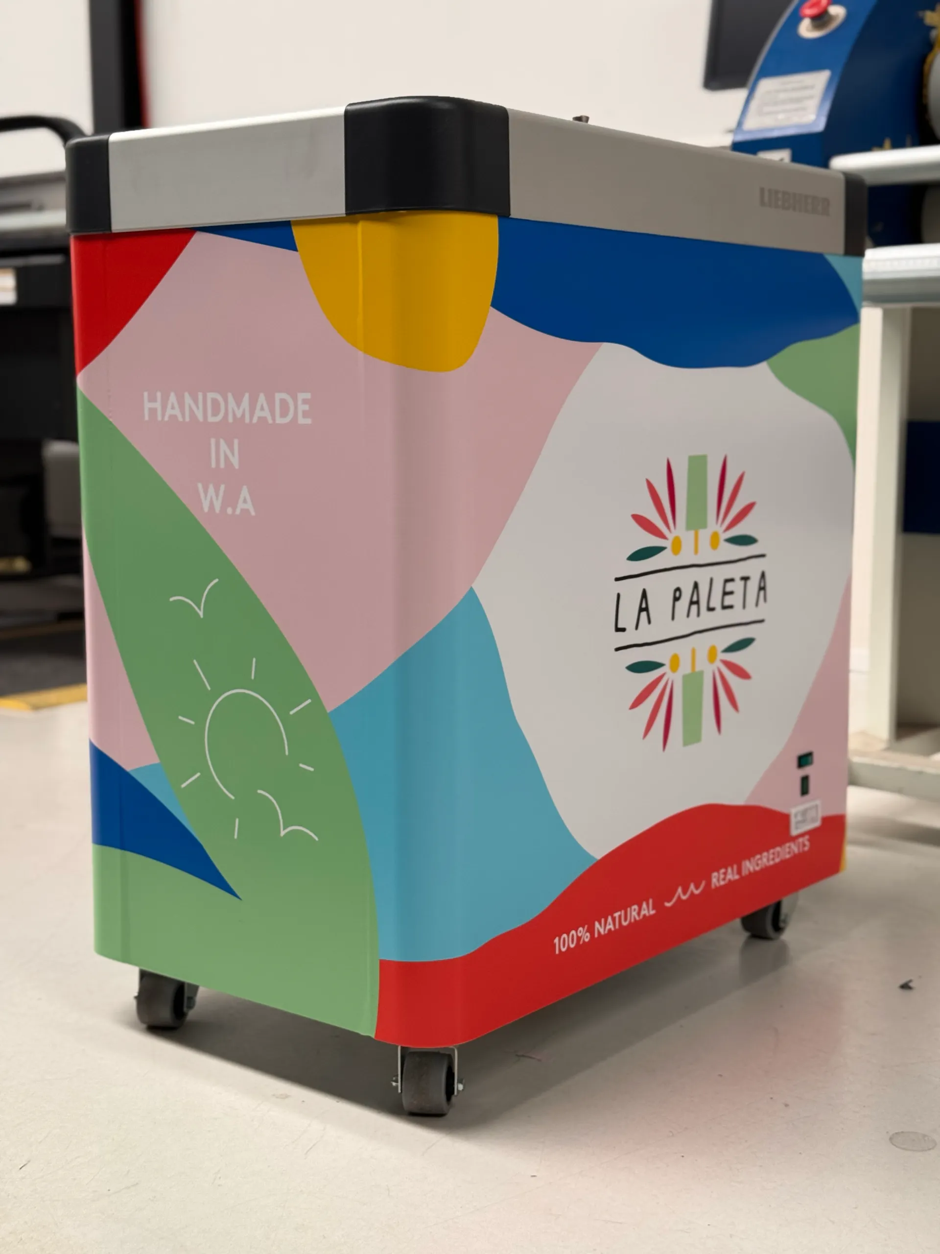 Colourful La Paleta freezer graphics extending around the side and front panels