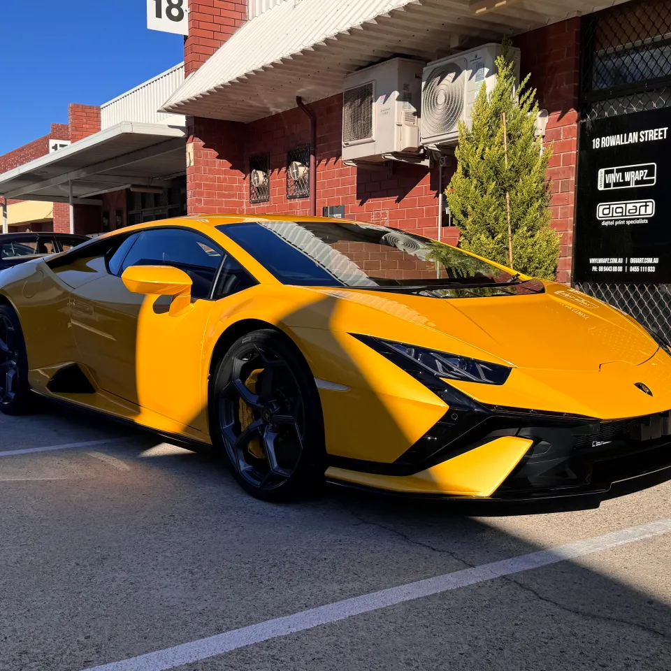Yellow Lamborghini Huracan Tecnica parked outside the workshop