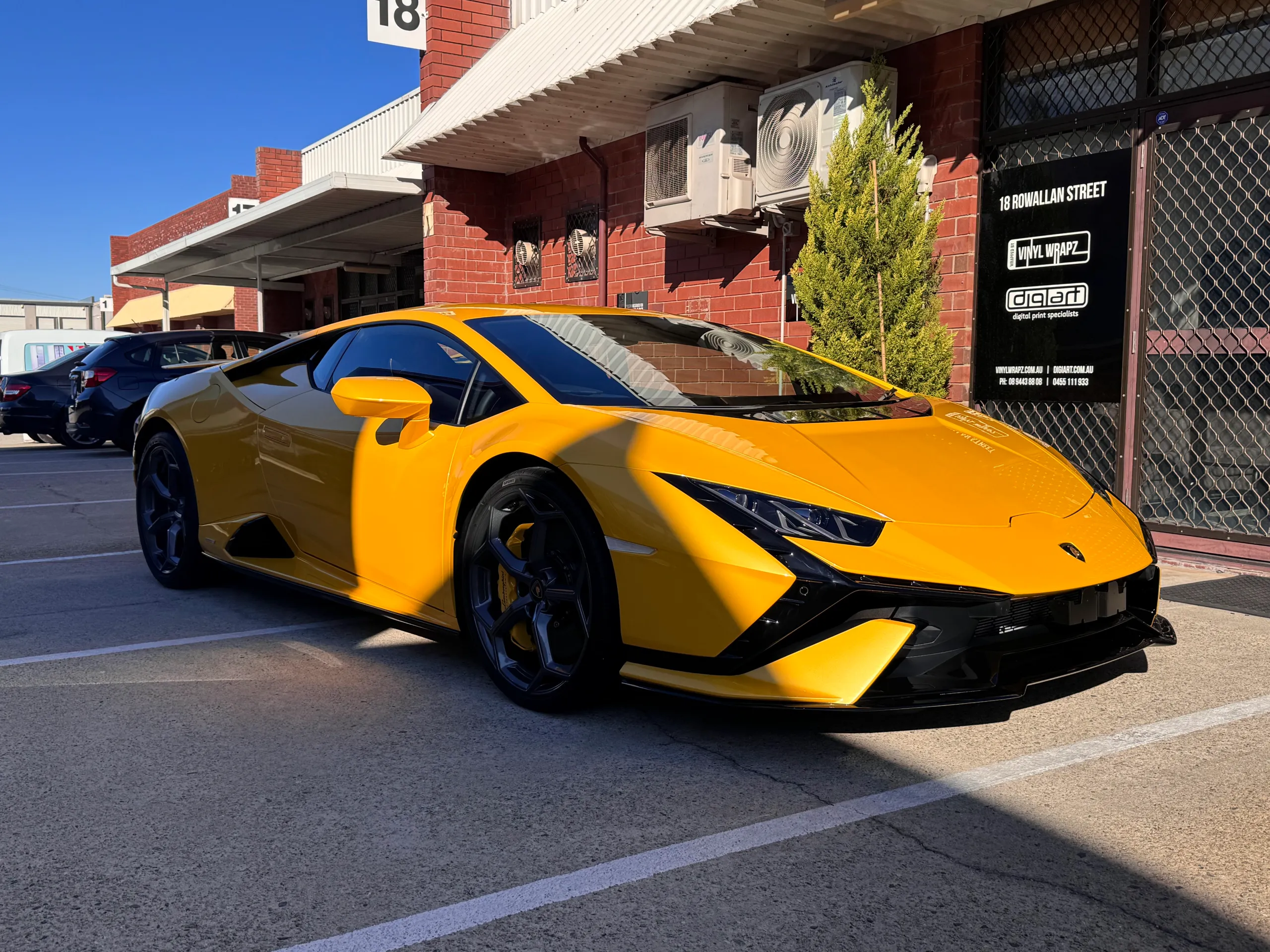 Yellow Lamborghini Huracan Tecnica parked outside the workshop