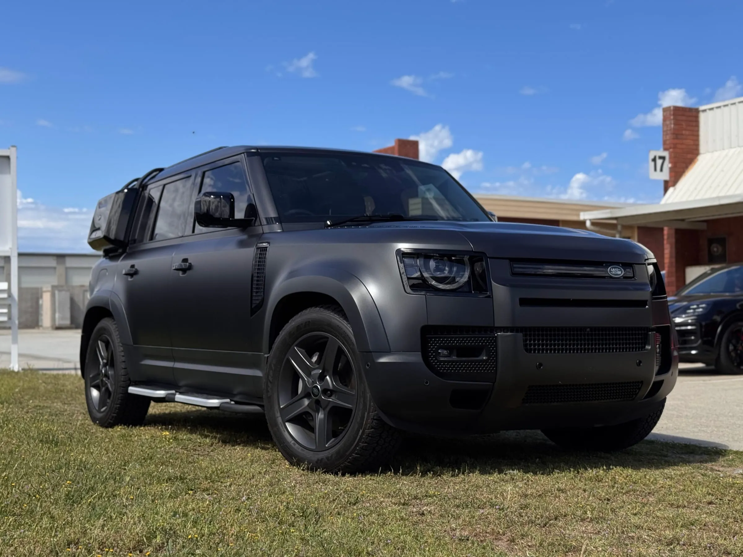Land Rover Defender 110 in satin black paint protection film outside the Vinyl Wrapz workshop, Perth