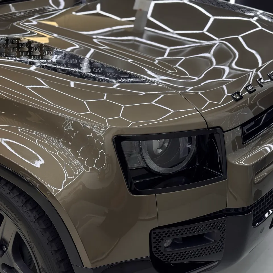 Land Rover Defender bonnet lettering, headlight and gloss bronze front bodywork in the workshop