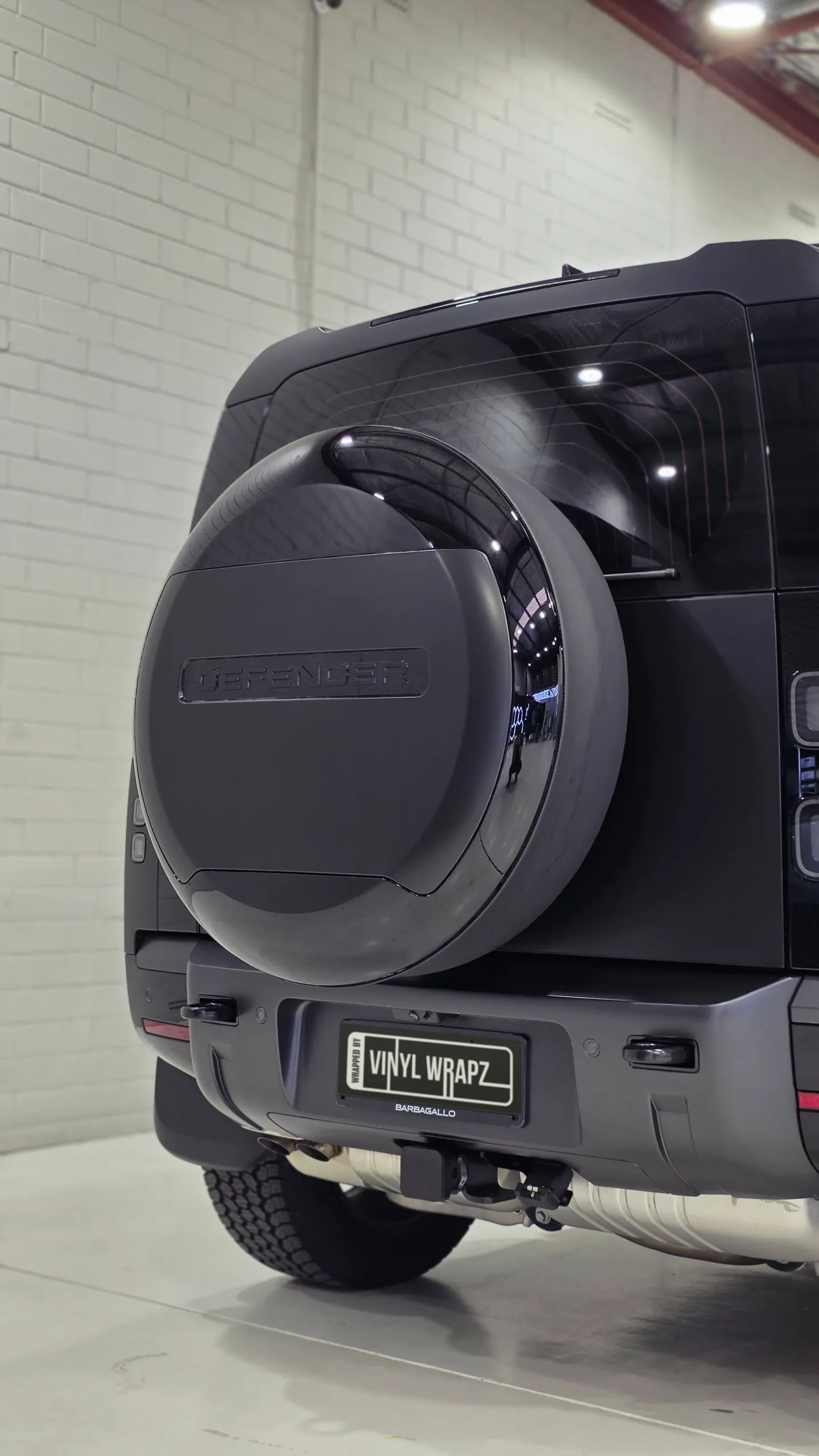 Rear-mounted spare wheel cover and matte dark grey tailgate on a Land Rover Defender